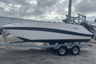 2021 Hurricane SunDeck Sport 192 RL OB boat on trailer, parked outdoors.