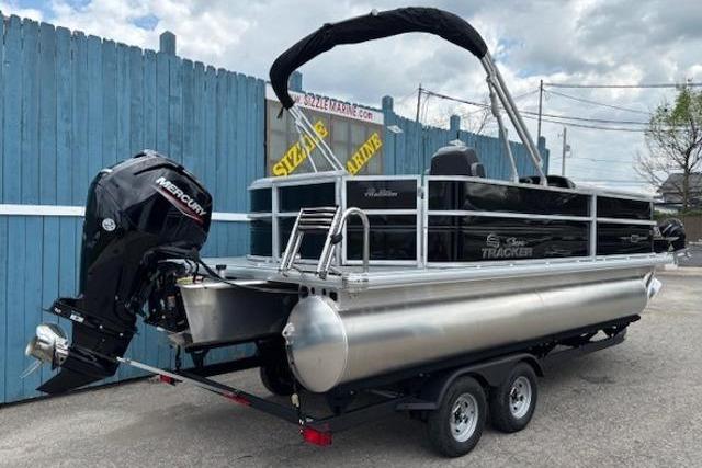 2026 Sun Tracker Party Barge 20 DLX pontoon boat on trailer, featuring Mercury outboard motor.