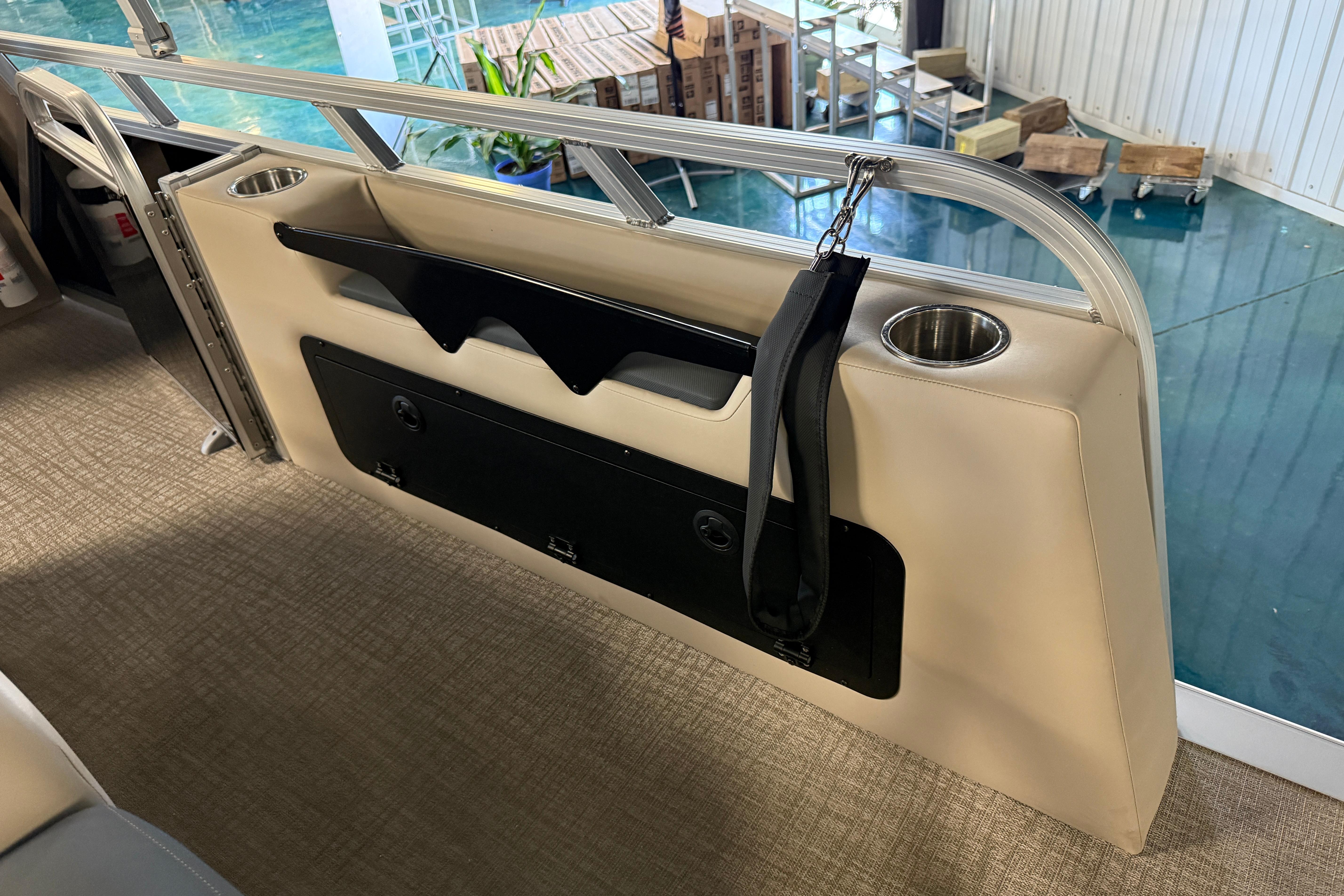 2026 Tahoe Pontoon LTZ Entertainer interior with cup holders and storage compartment.