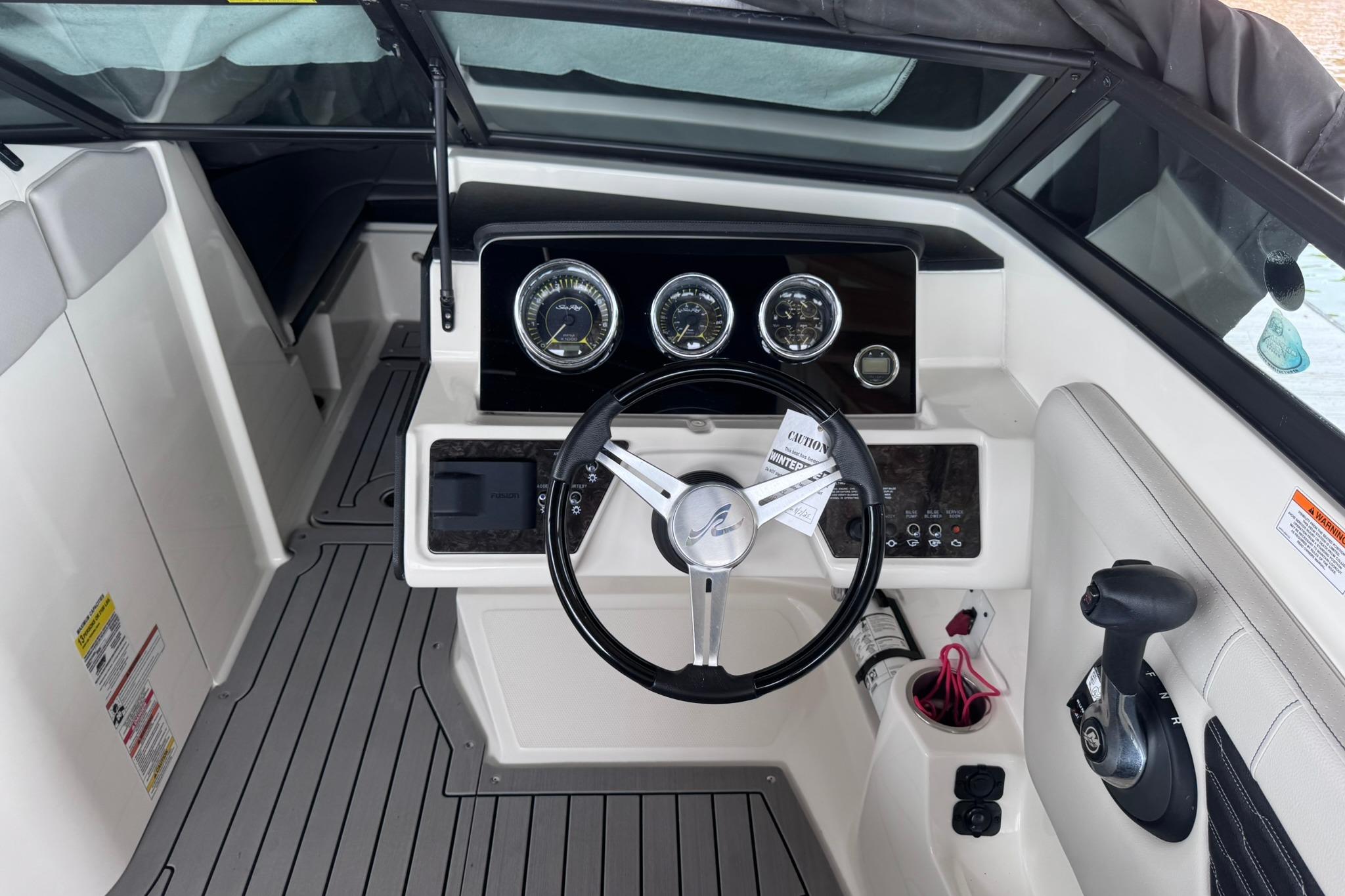 2021 Sea Ray SPX 230 boat dashboard with steering wheel and control panel.