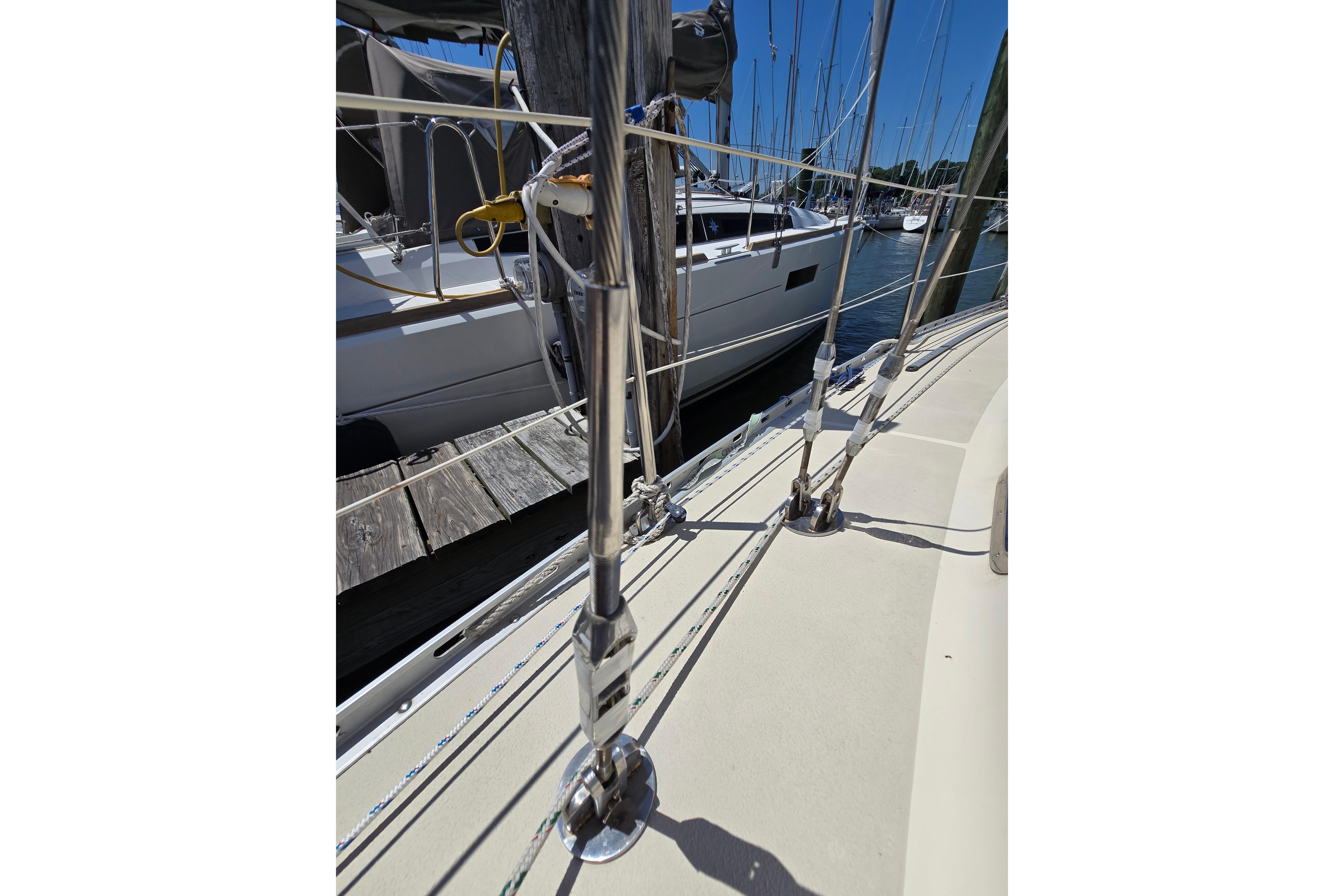 Sailboat deck view of 1993 Caliber 35, docked with rigging details.