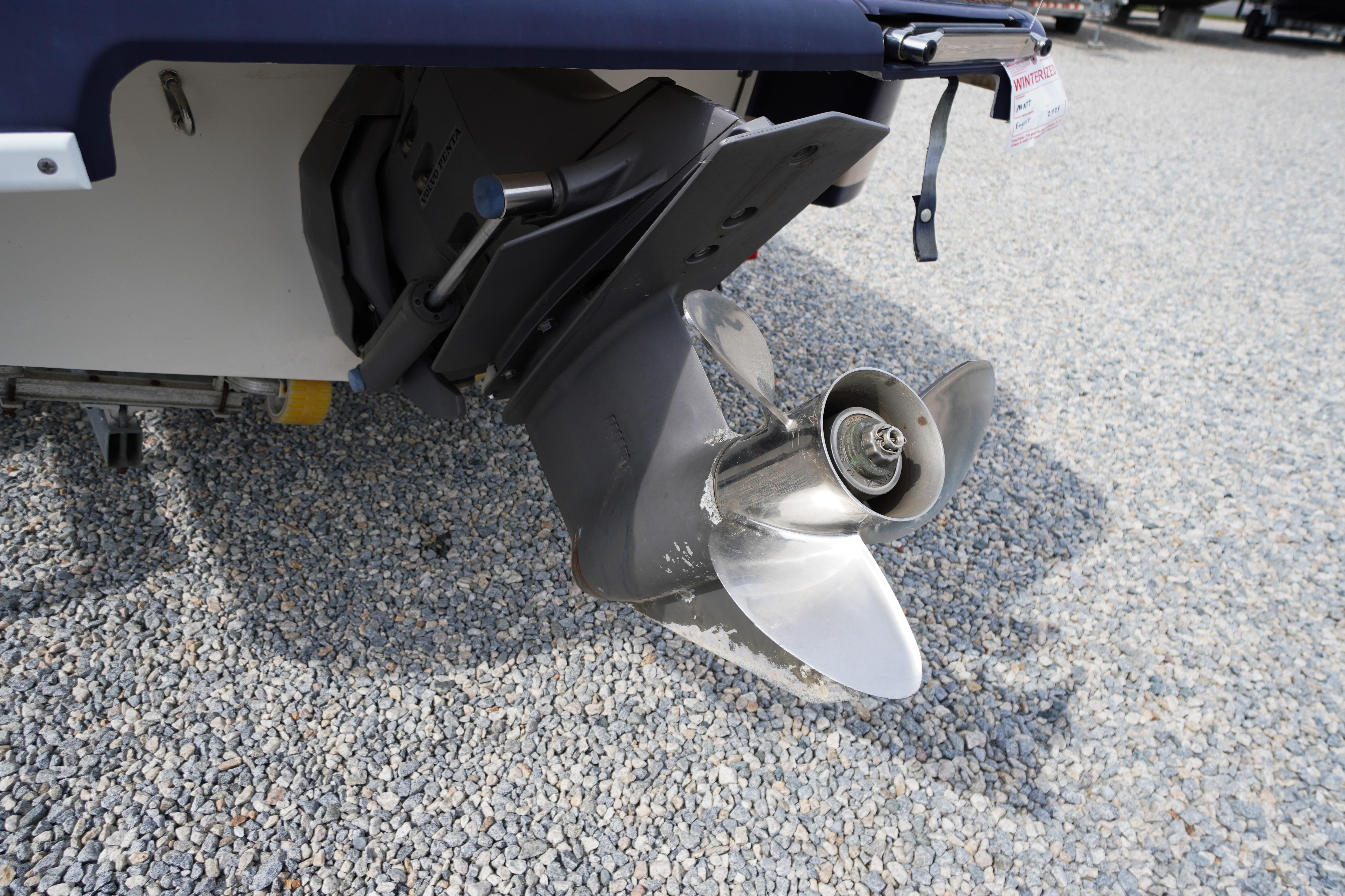 Propeller of a 2005 Chris Craft Speedster Heritage boat on gravel surface.