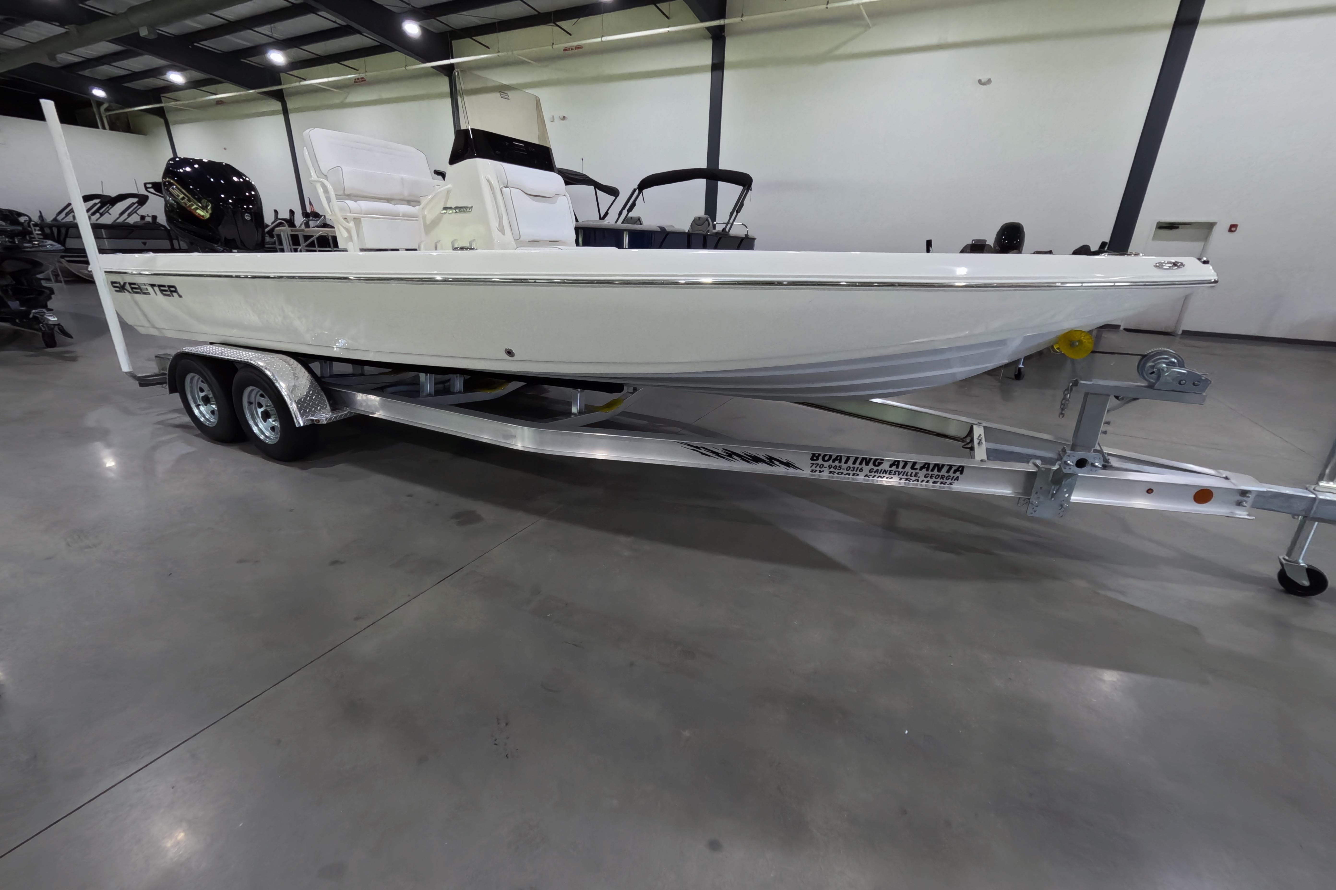 2026 Skeeter SX230 boat on trailer in showroom, side view.