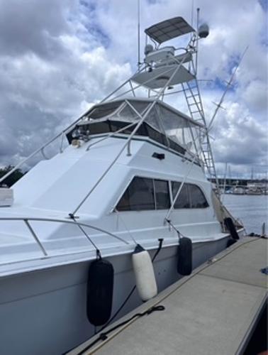 1986 Egg Harbor 60 Sportfisherman docked under cloudy skies.
