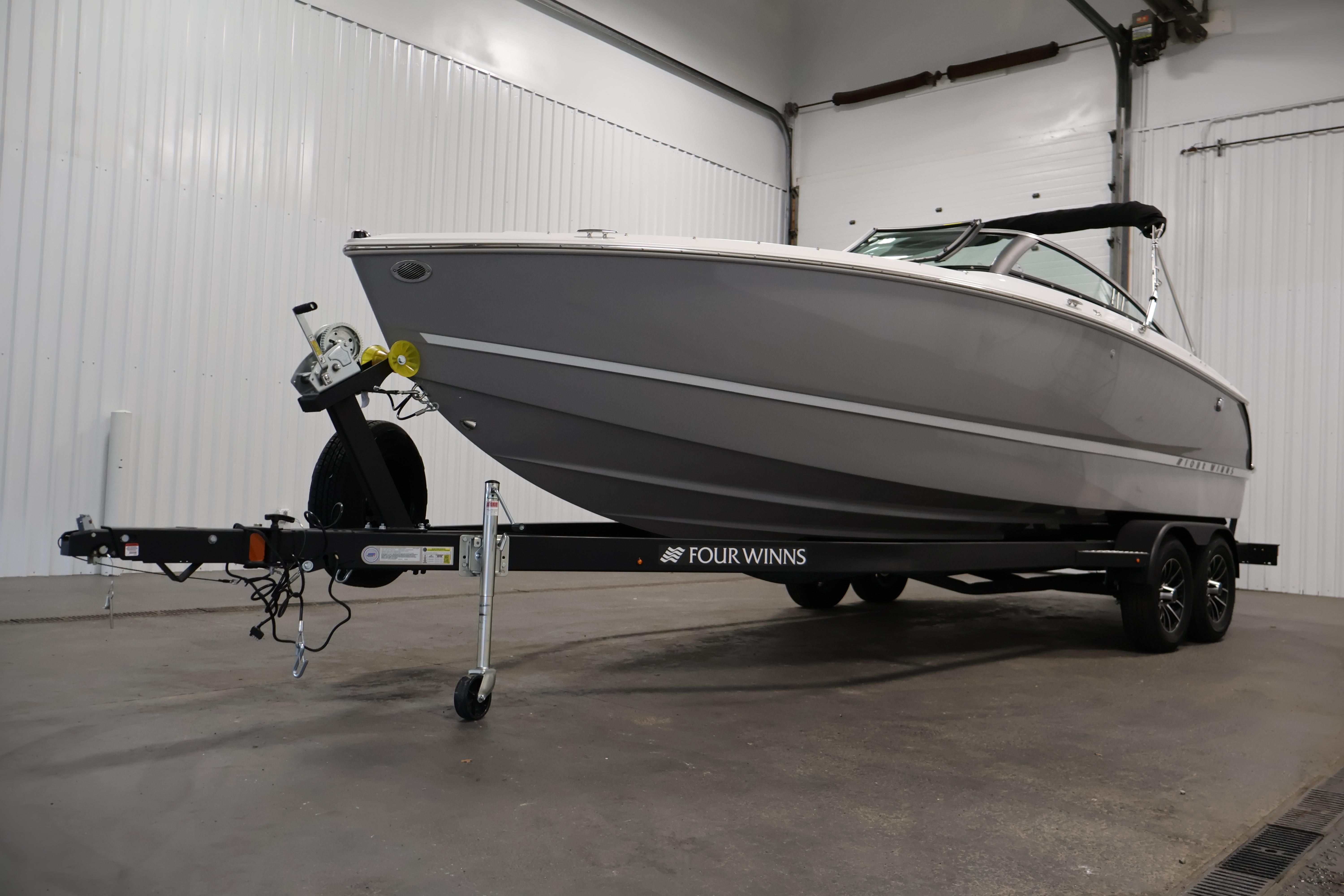 2026 Four Winns H4 Freedom boat on trailer in indoor storage.