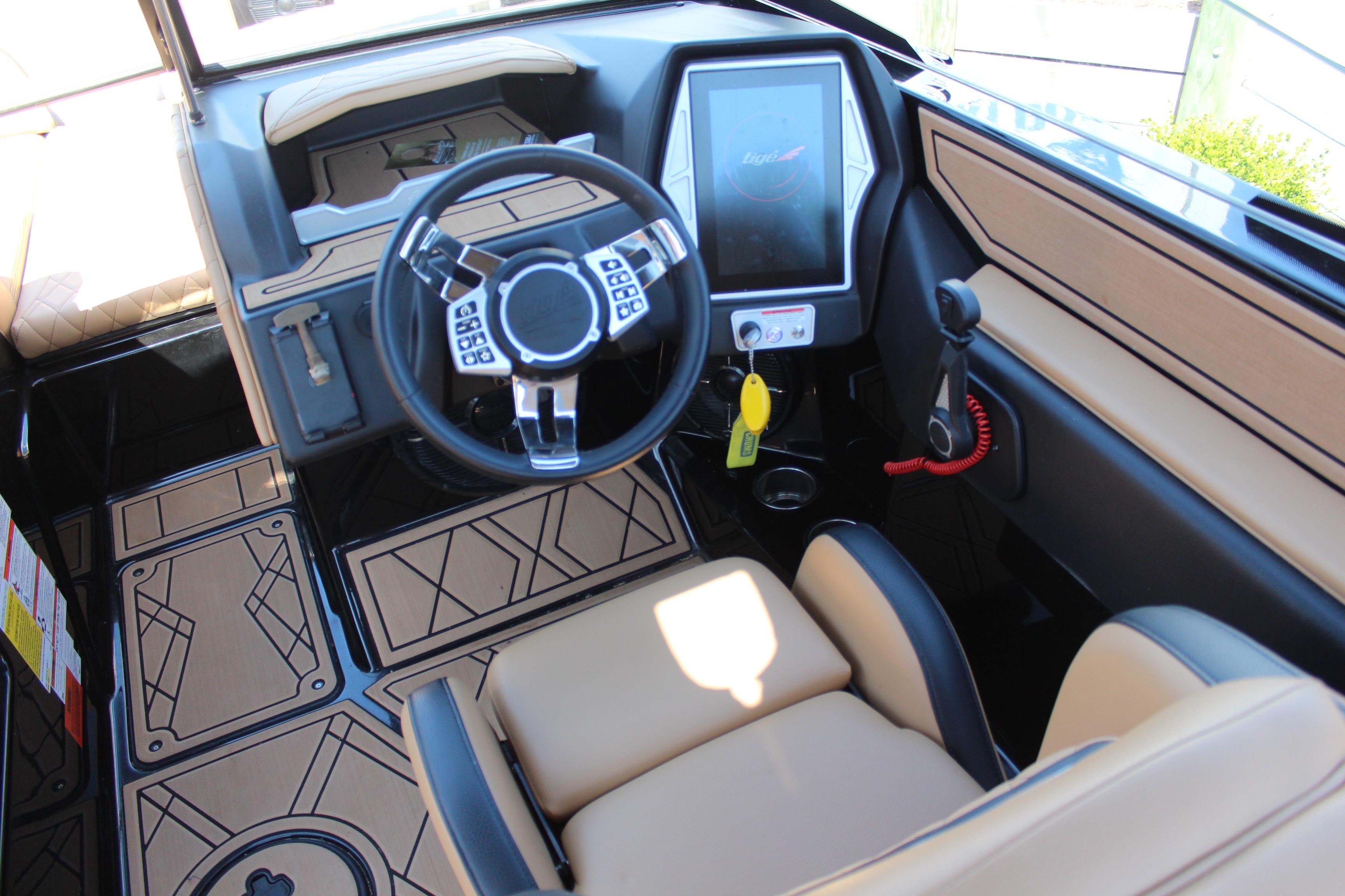 Interior of 2022 Tigé 22RZX boat featuring modern steering and touchscreen controls.