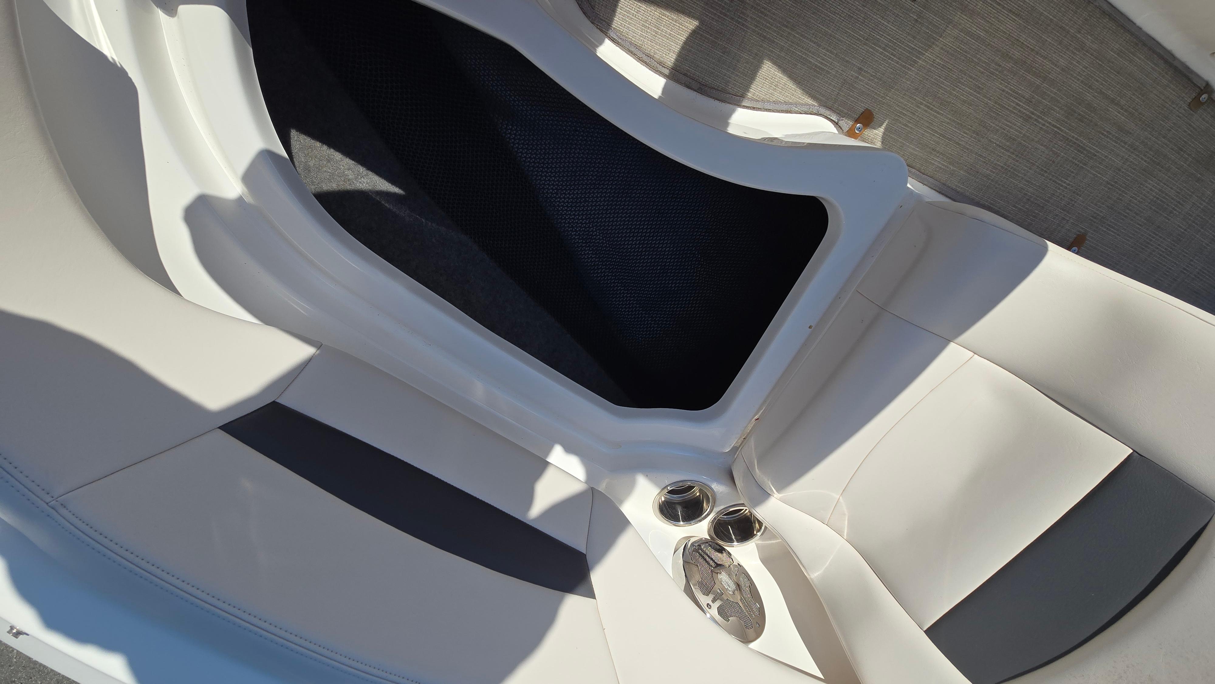 2018 Chaparral 224 Sunesta boat interior with seating and cup holders.