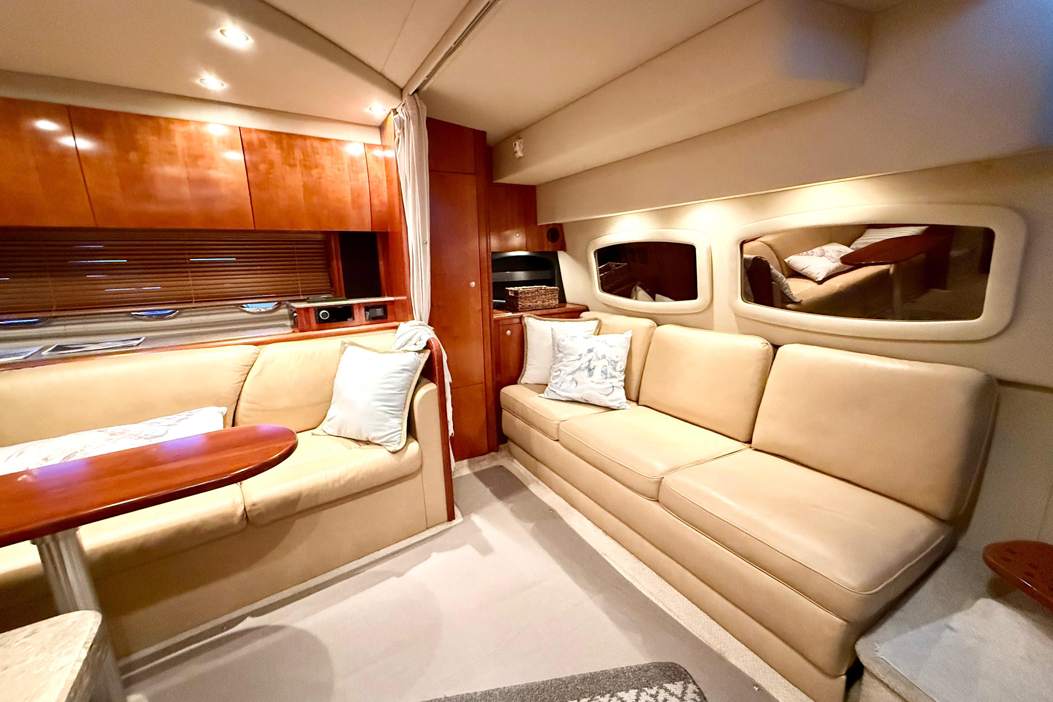 Luxurious interior of 2011 Cruisers Yachts 390 Sports Coupe with beige seating and wooden accents.