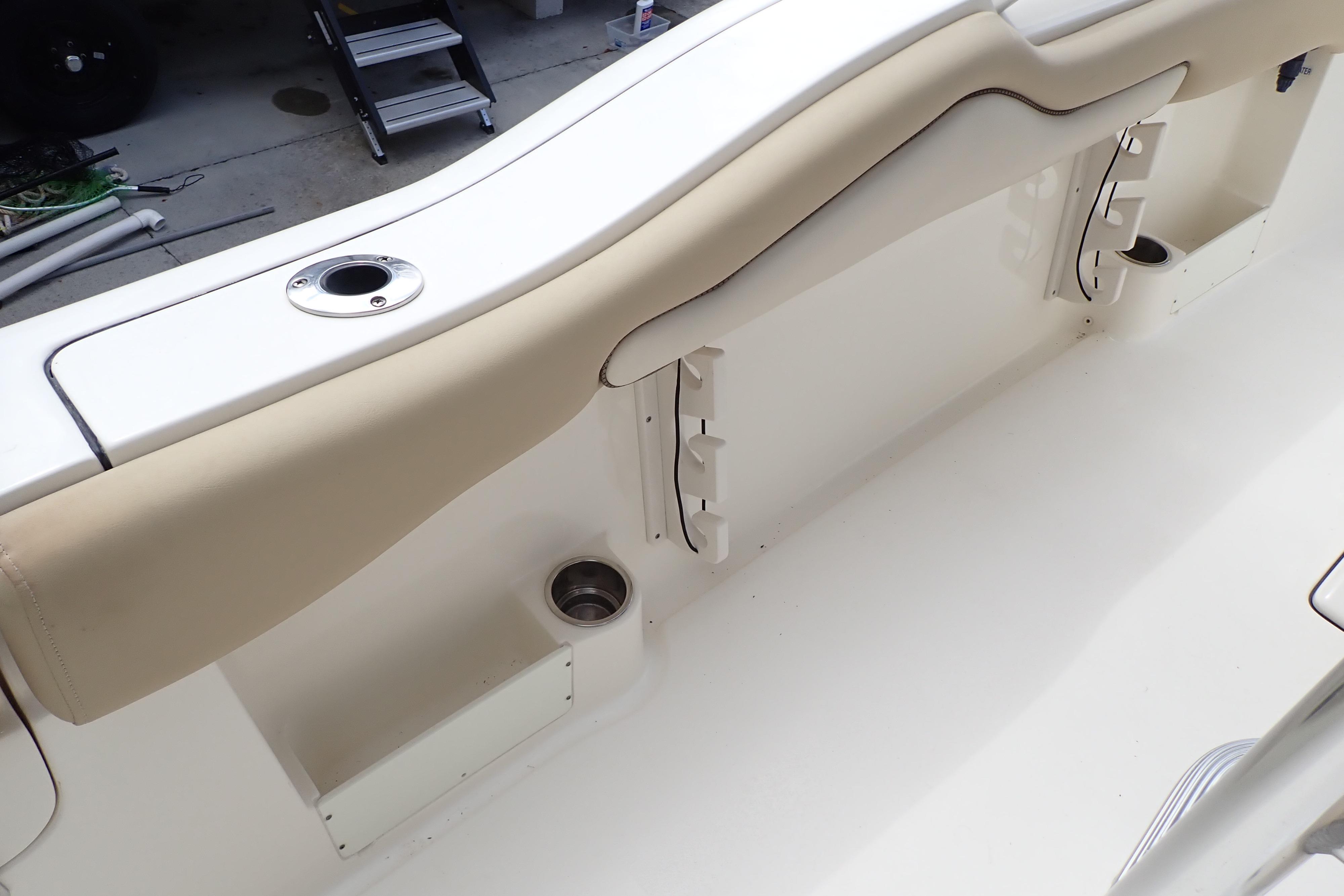2019 Key West 263 FS boat interior with beige seating and cup holders.