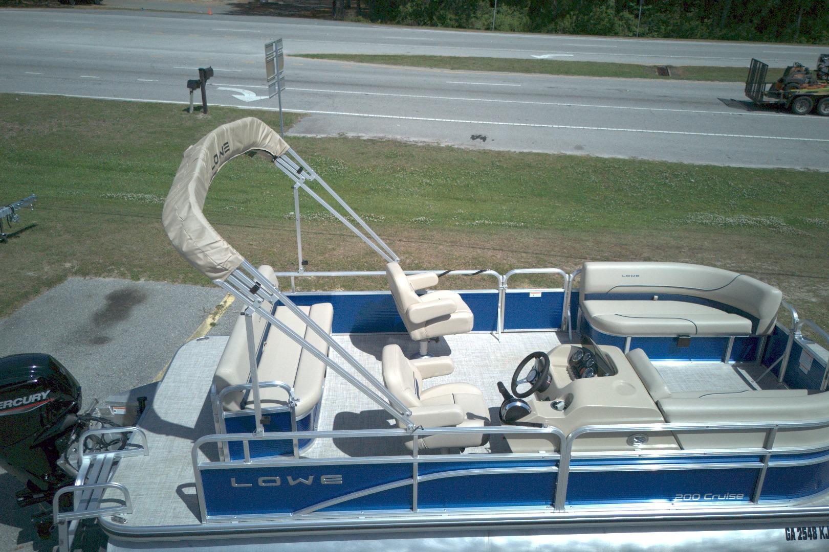 2024 Lowe Ultra 200 Cruise pontoon boat with beige seating and blue exterior.