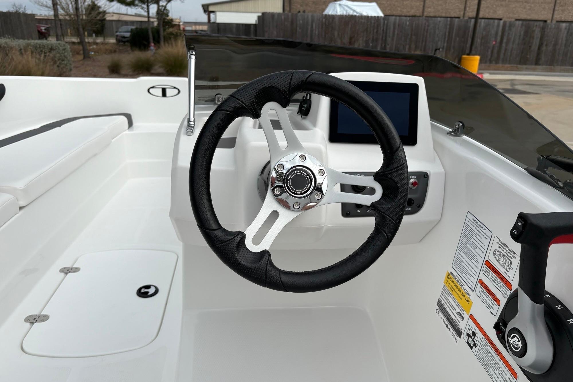 2025 Tahoe T16 boat cockpit with steering wheel and control panel.