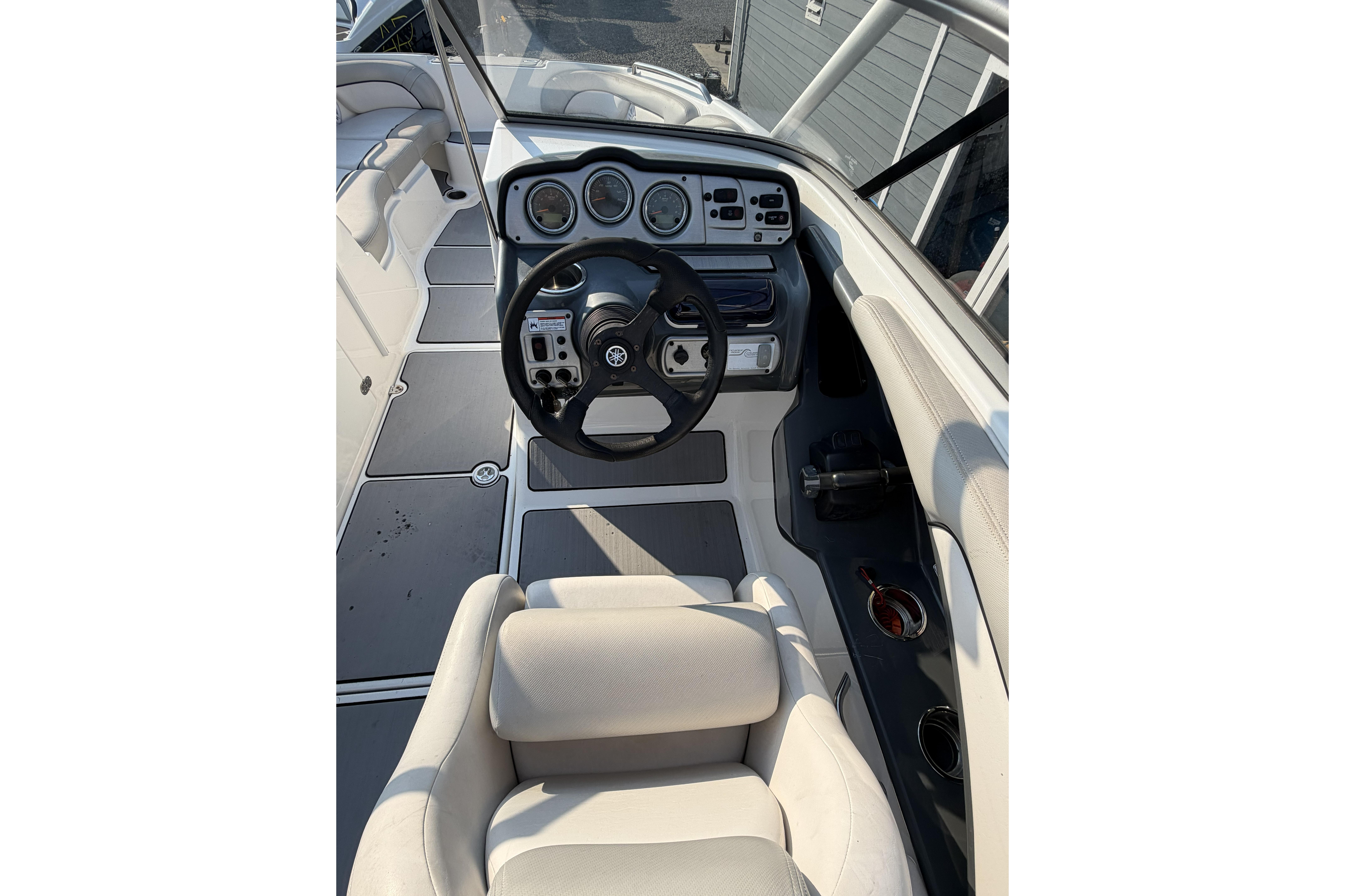 2011 Yamaha Boats AR240 HO cockpit with steering wheel and dashboard controls.