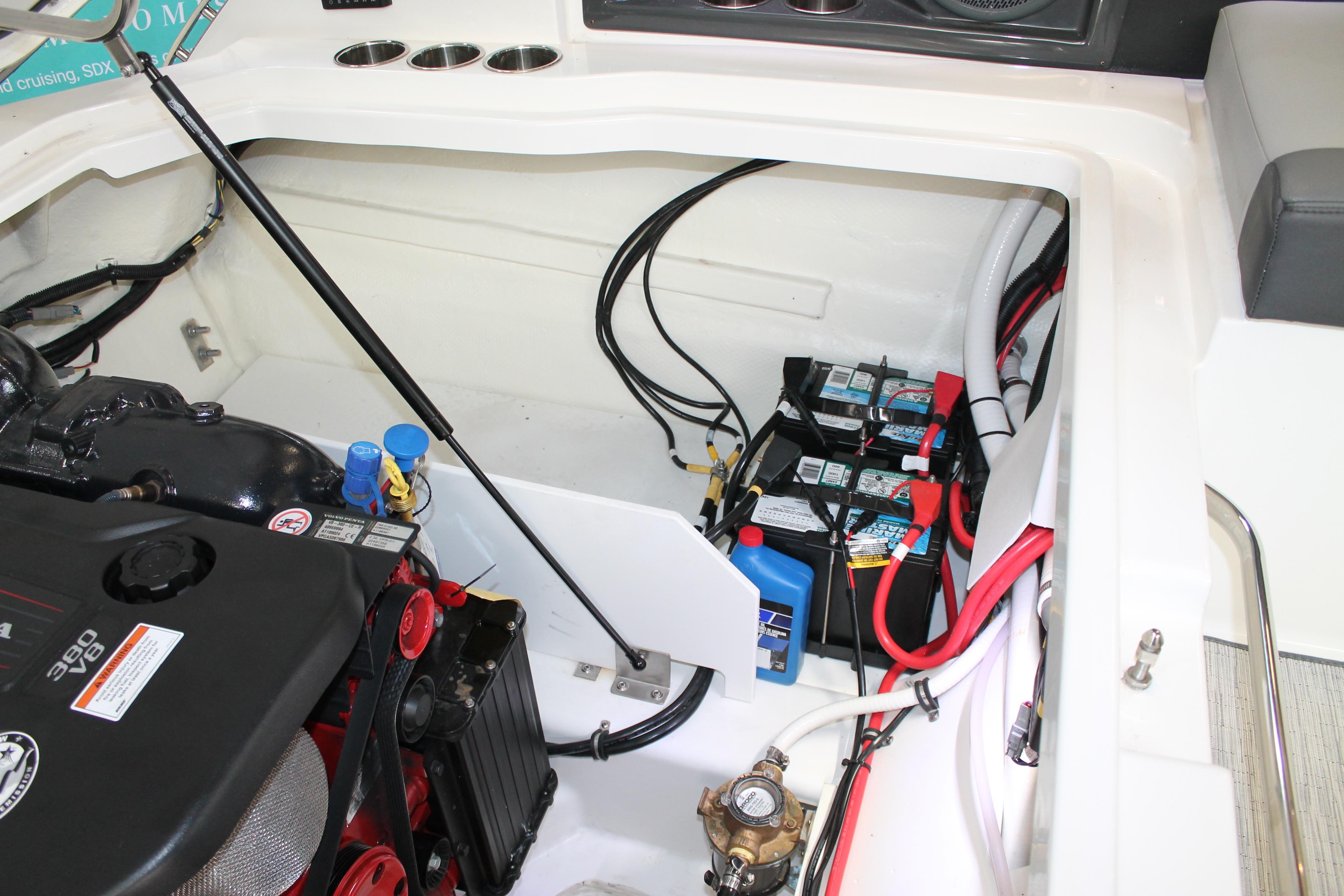 Engine compartment of a 2023 Cobalt R8 boat, featuring batteries and wiring.