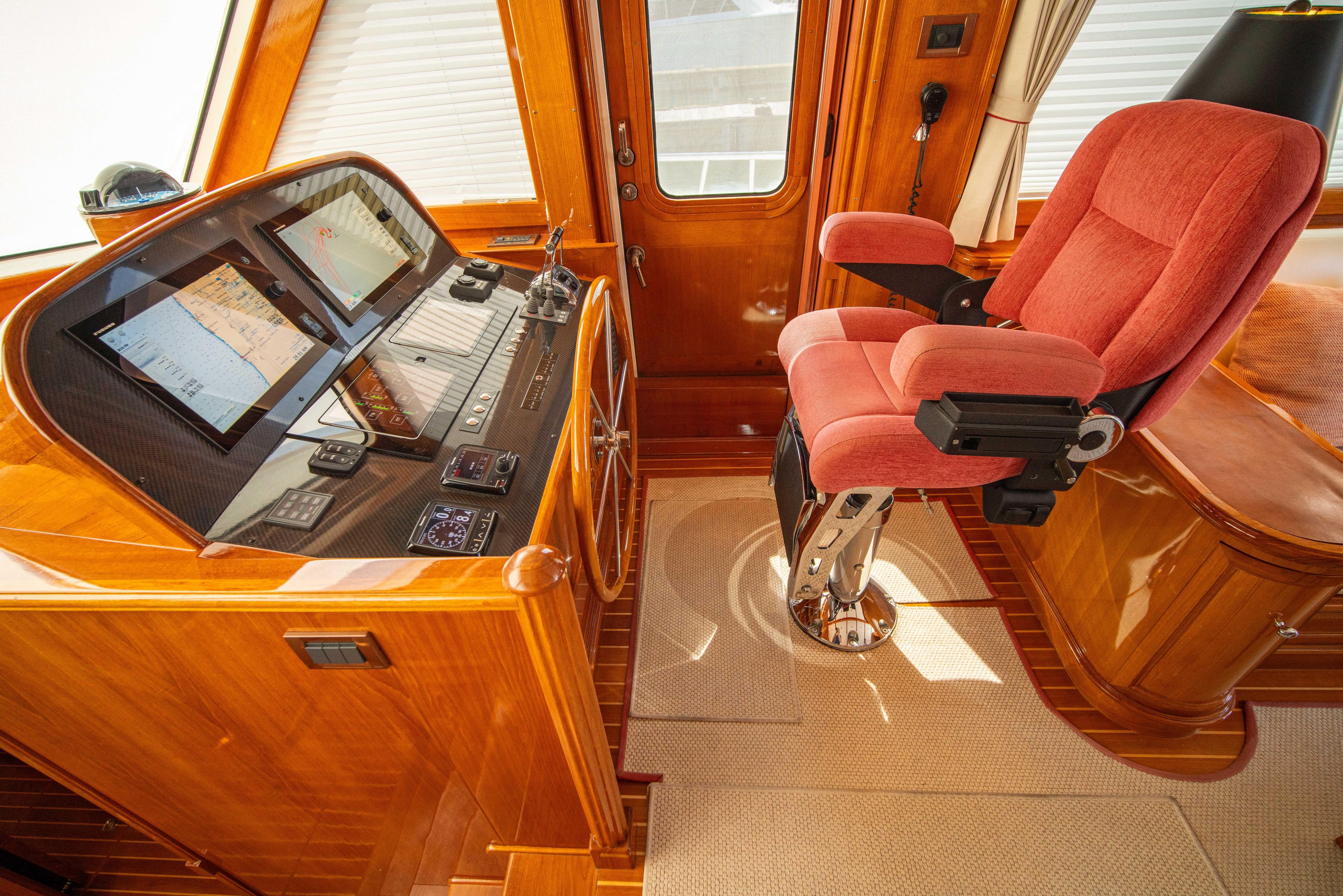 Luxurious helm of 2004 Grand Banks 58 Eastbay FB with plush captain's chair.