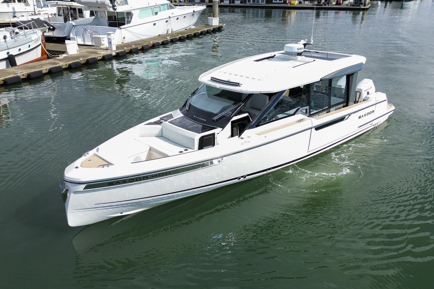 2026 Saxdor 400 GTC luxury boat docked in a marina, showcasing sleek design and modern features.