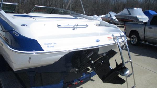 2012 Crownline 21 SS boat with ladder, parked near a truck.