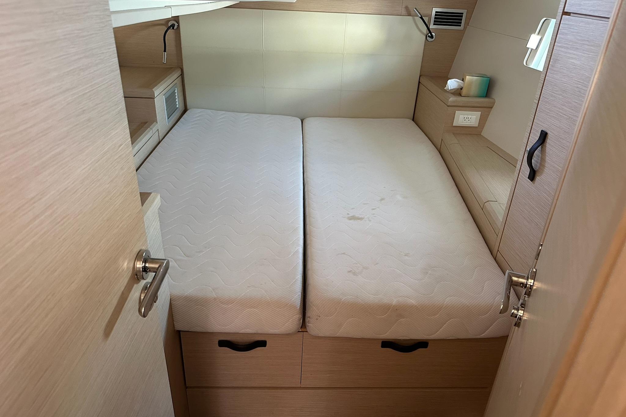 Interior cabin of a 2018 Jeanneau 51 yacht with twin beds and modern design.