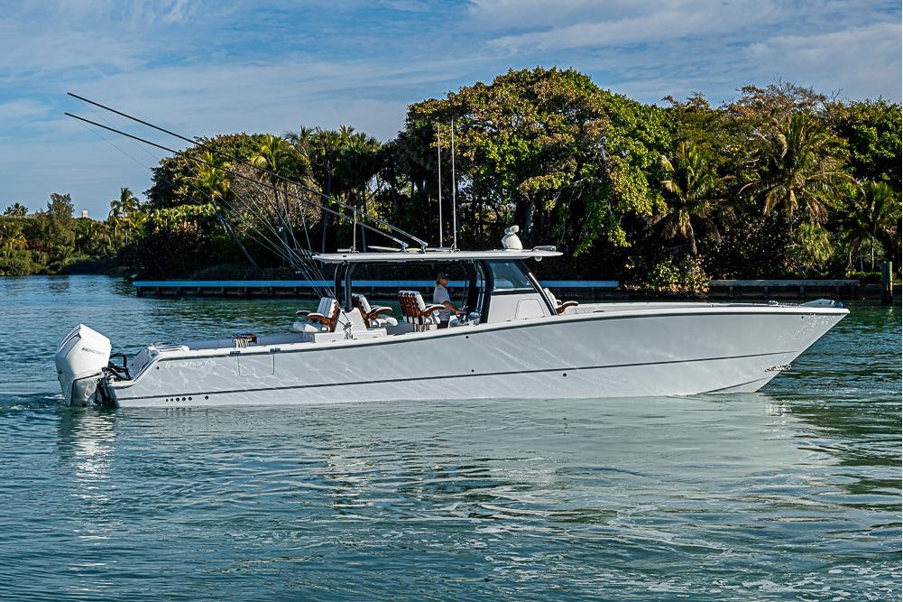 2023 Freeman 47 boat cruising on a serene waterway with lush greenery.
