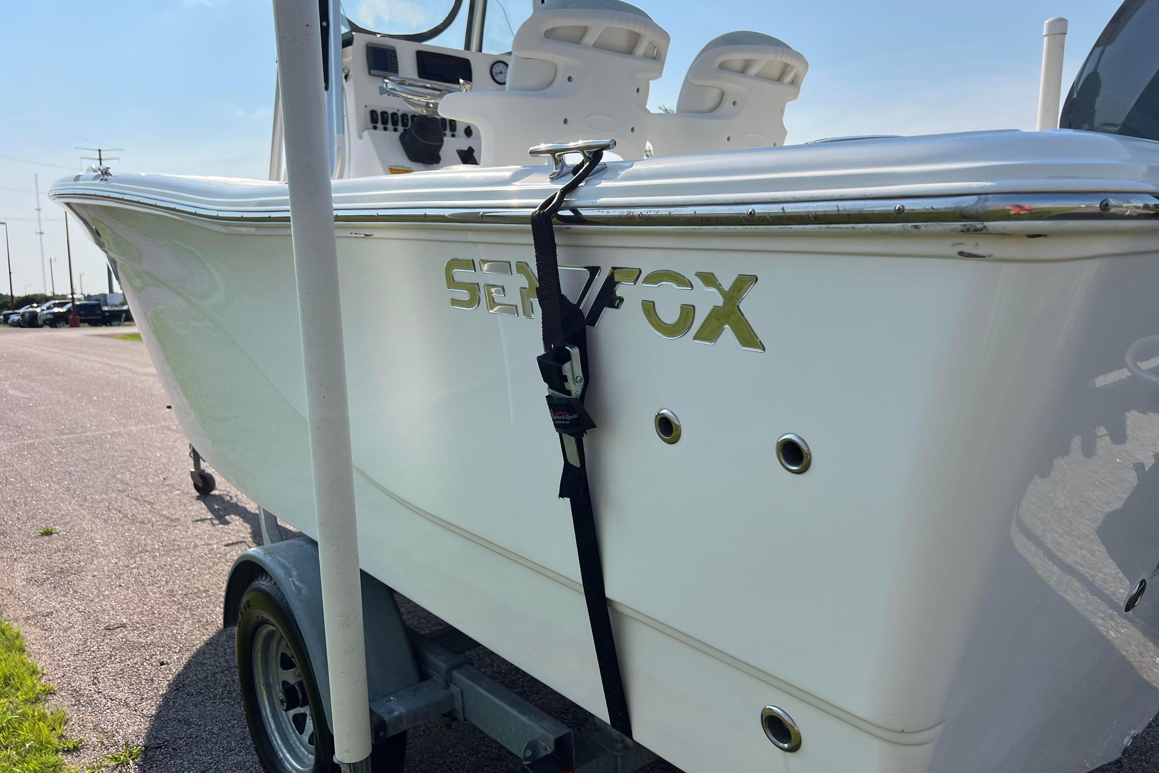 2012 Sea Fox 206 Center Console boat on trailer, side view with logo visible.