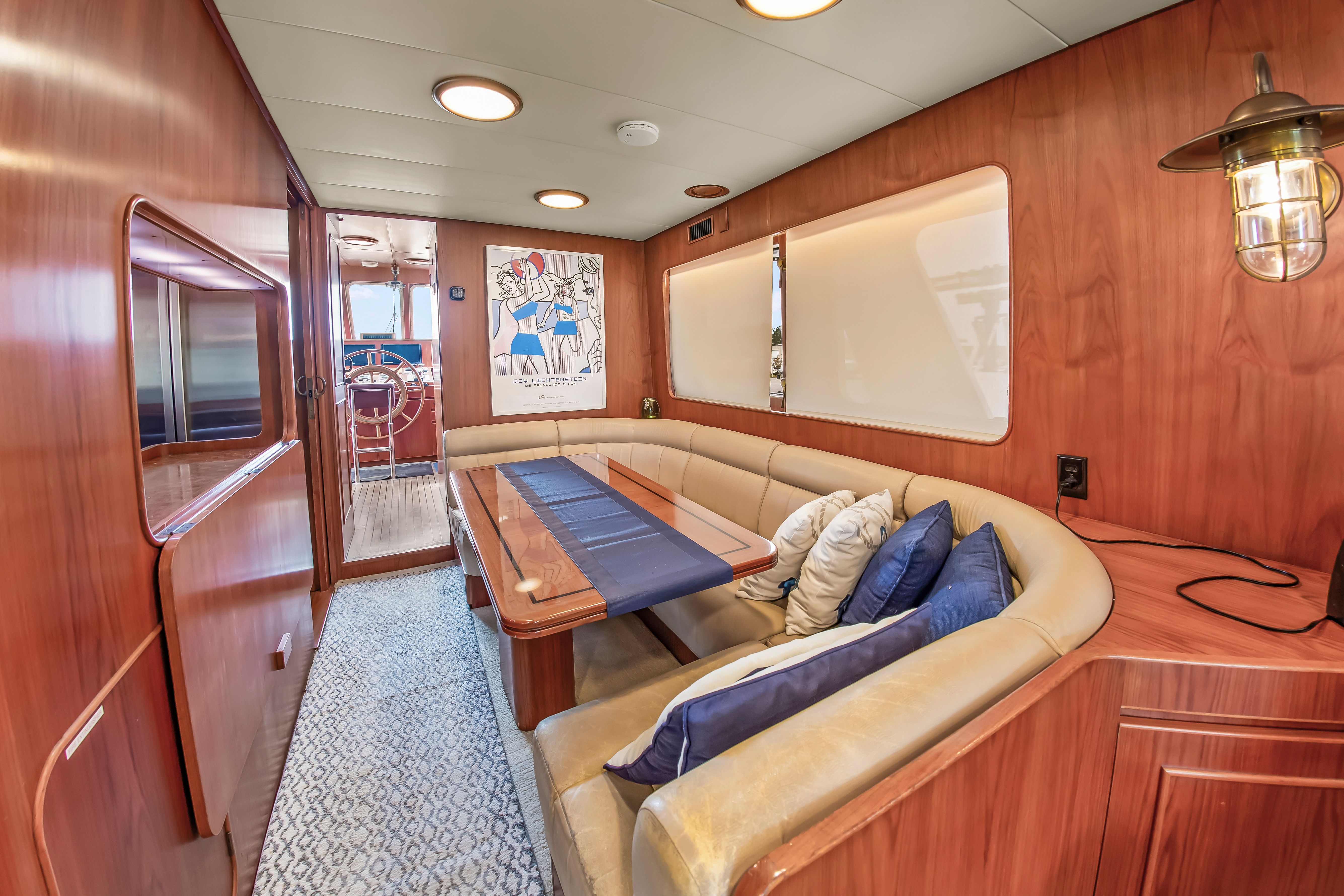 Interior of a 1987 Jongert 78 Motor Yacht with elegant wood finish and cozy seating area.