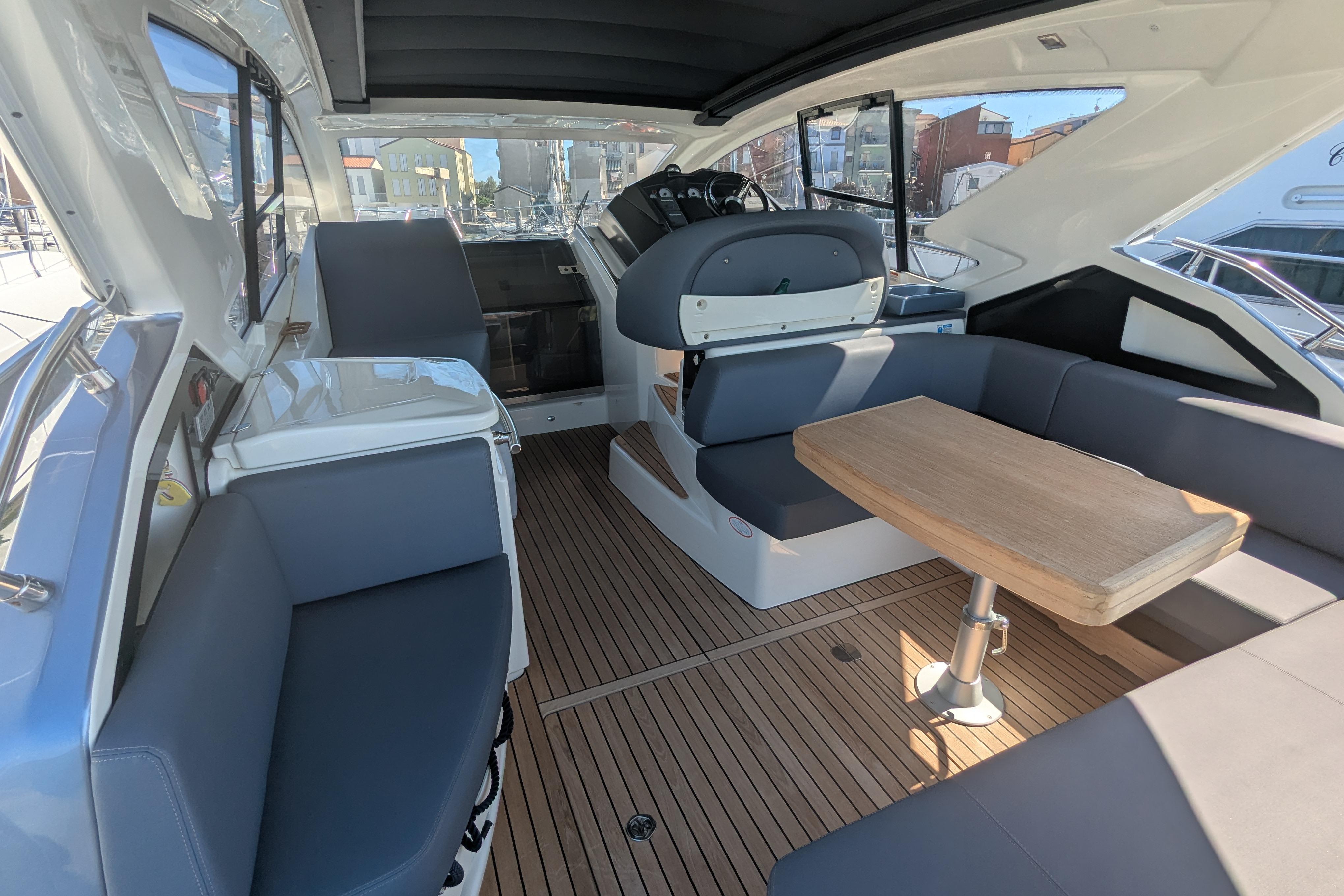 2016 Cranchi M 44 HT yacht interior with sleek seating and wooden table.