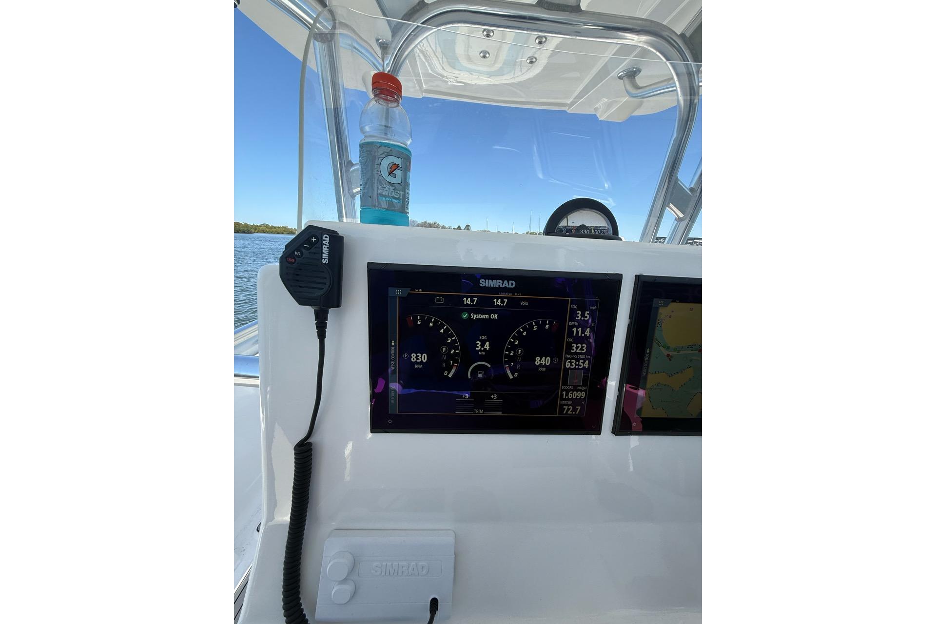 Center console of 2021 Custom Infusion 34 CC boat with Simrad display and Gatorade bottle.