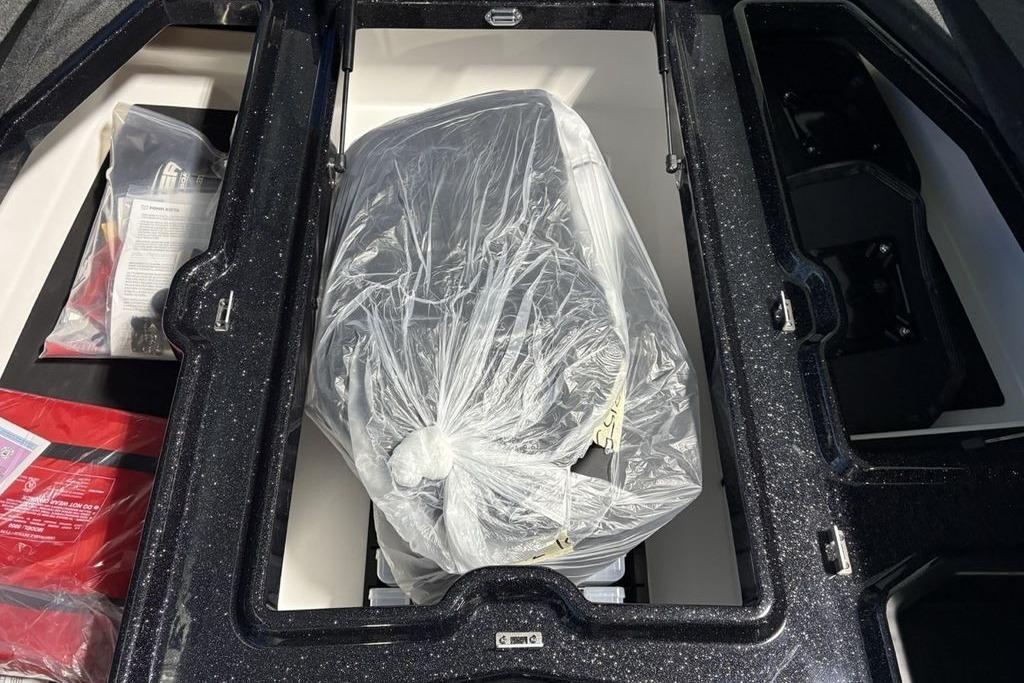 2026 Skeeter ZXE21 boat storage compartment with packaged equipment inside.