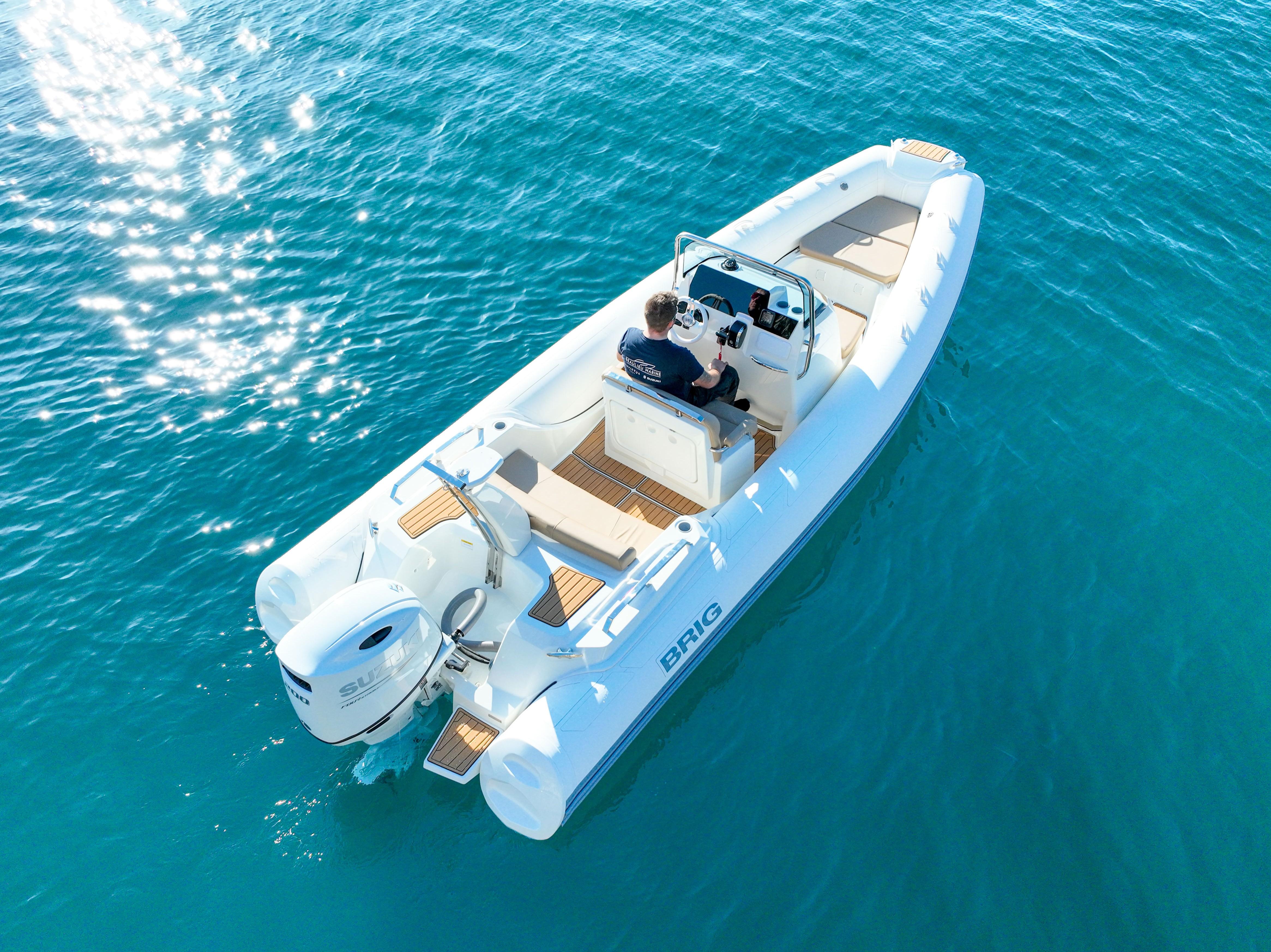 2025 Brig Eagle 6.7 boat cruising on clear blue water, aerial view.