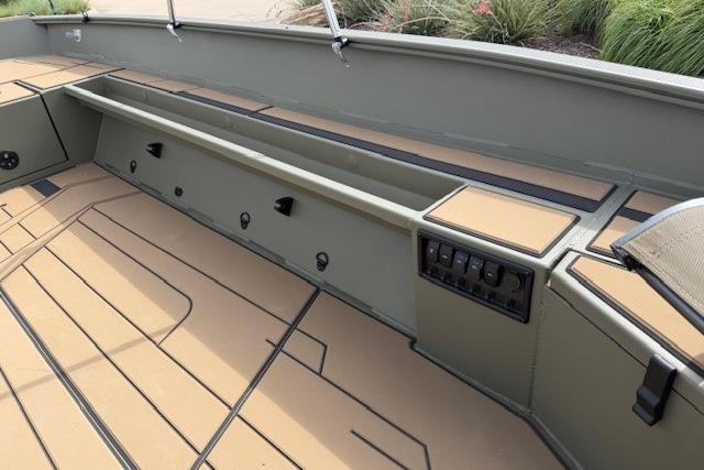 2026 Tracker Grizzly 1756 T Marsh boat interior with storage compartments and control panel.