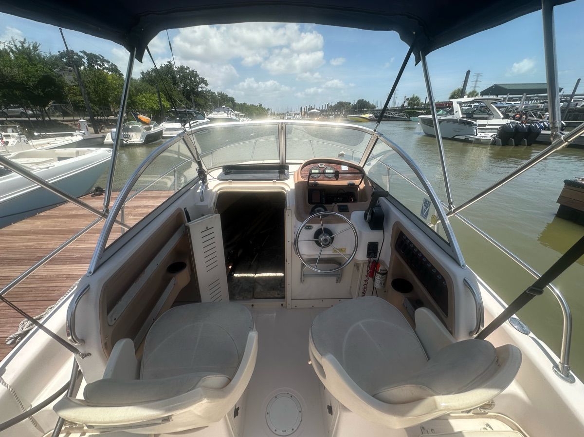 The image shows the cockpit of a 1998 Grady-White Adventure 208. It is docked.