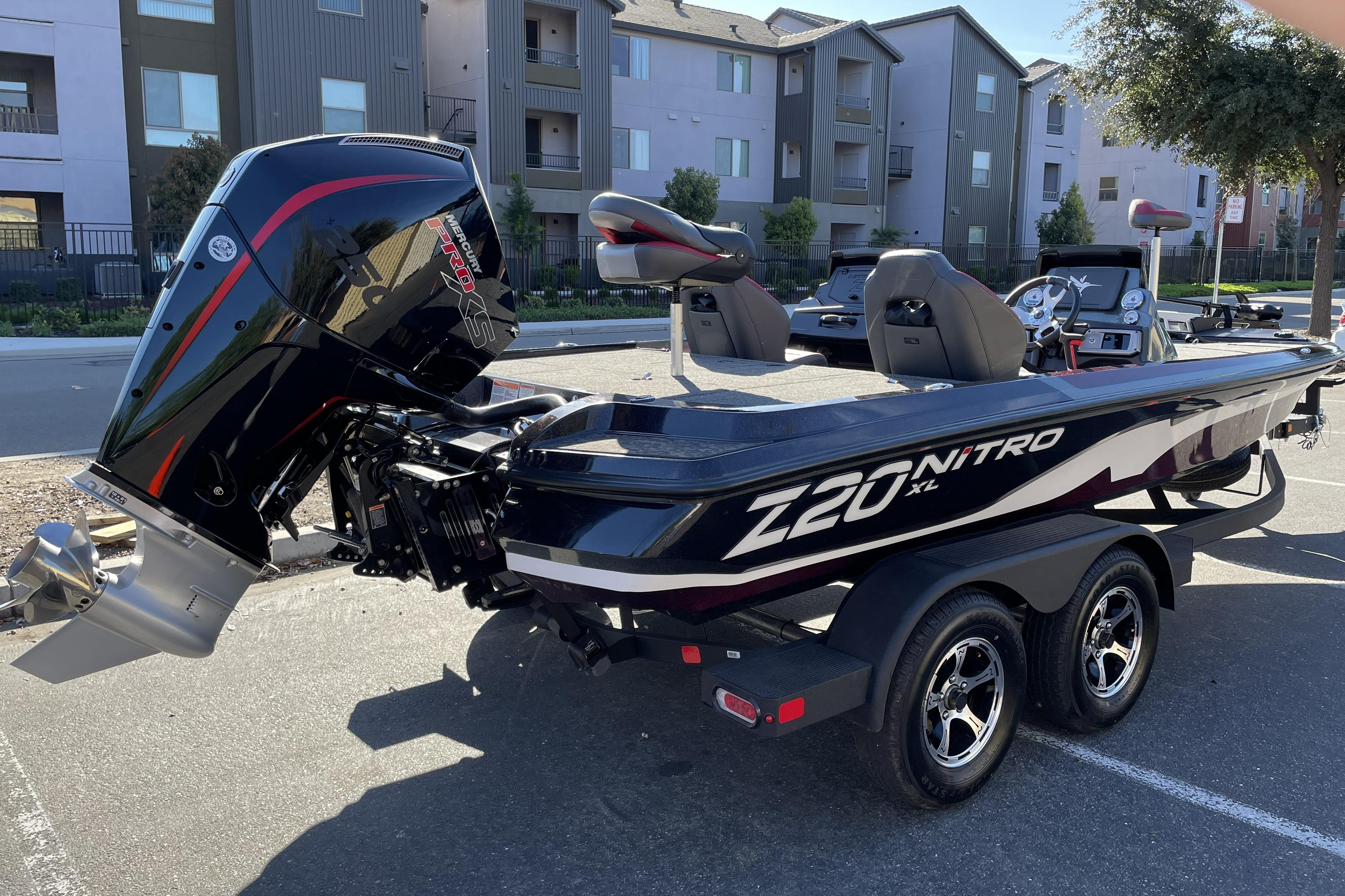 2026 Nitro Z20 XL boat with powerful outboard motor, parked in urban setting.