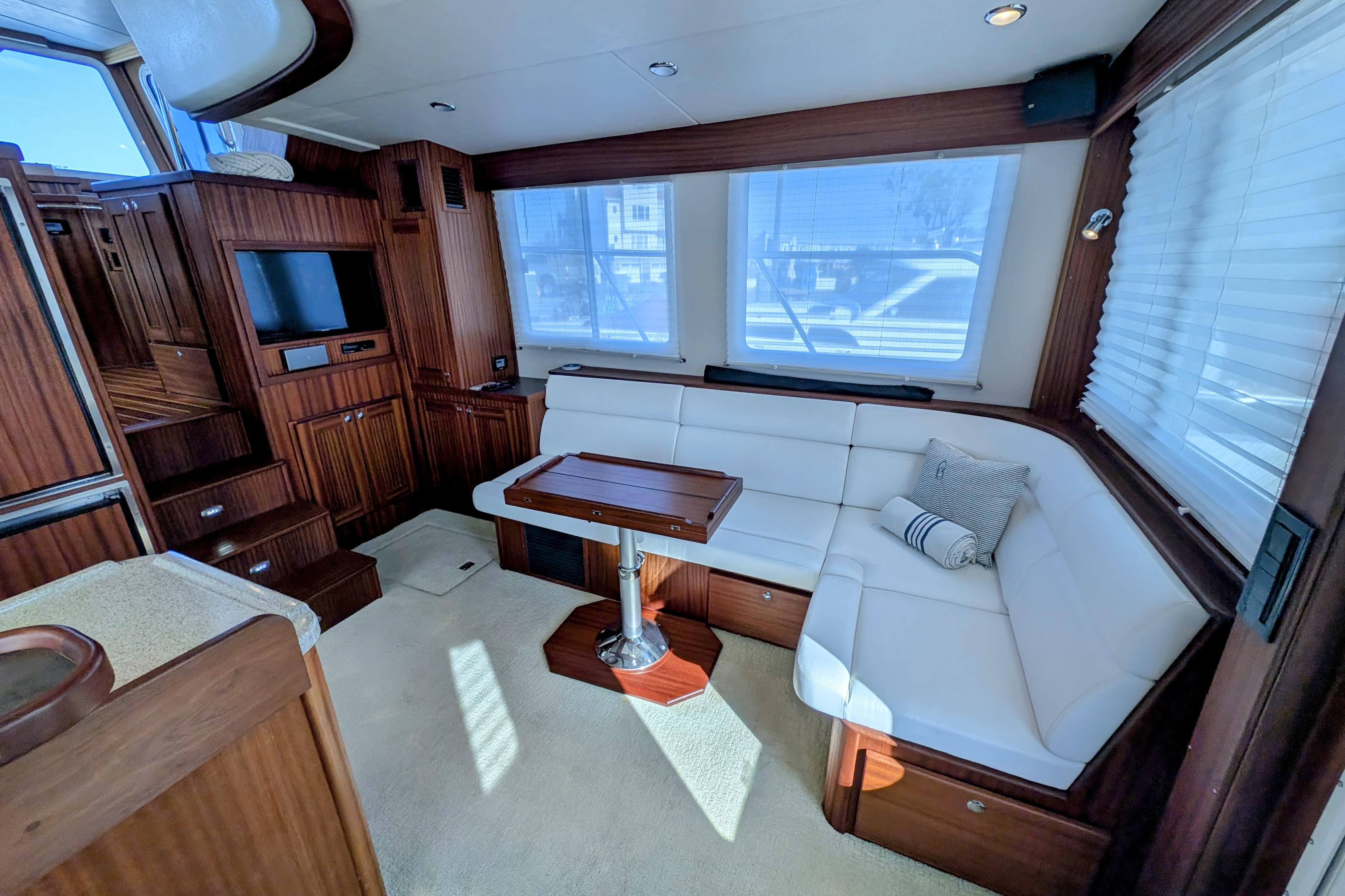 Luxurious interior of 2015 American Tug 435 with plush seating and elegant wood finishes.