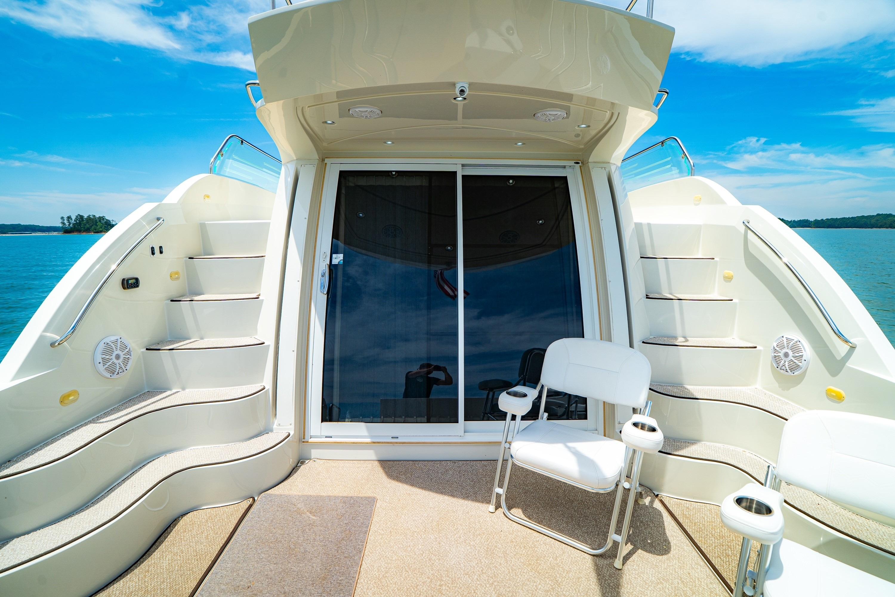 2011 Carver 44 Sojourn yacht deck with seating, stairs, and ocean view.