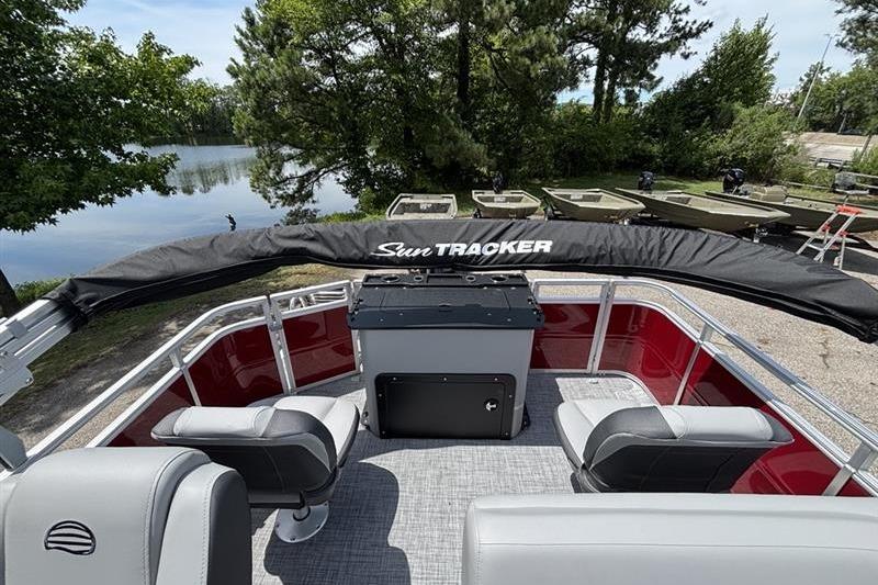 2026 Sun Tracker SportFish 20 DLX pontoon boat interior with seating and covered console.