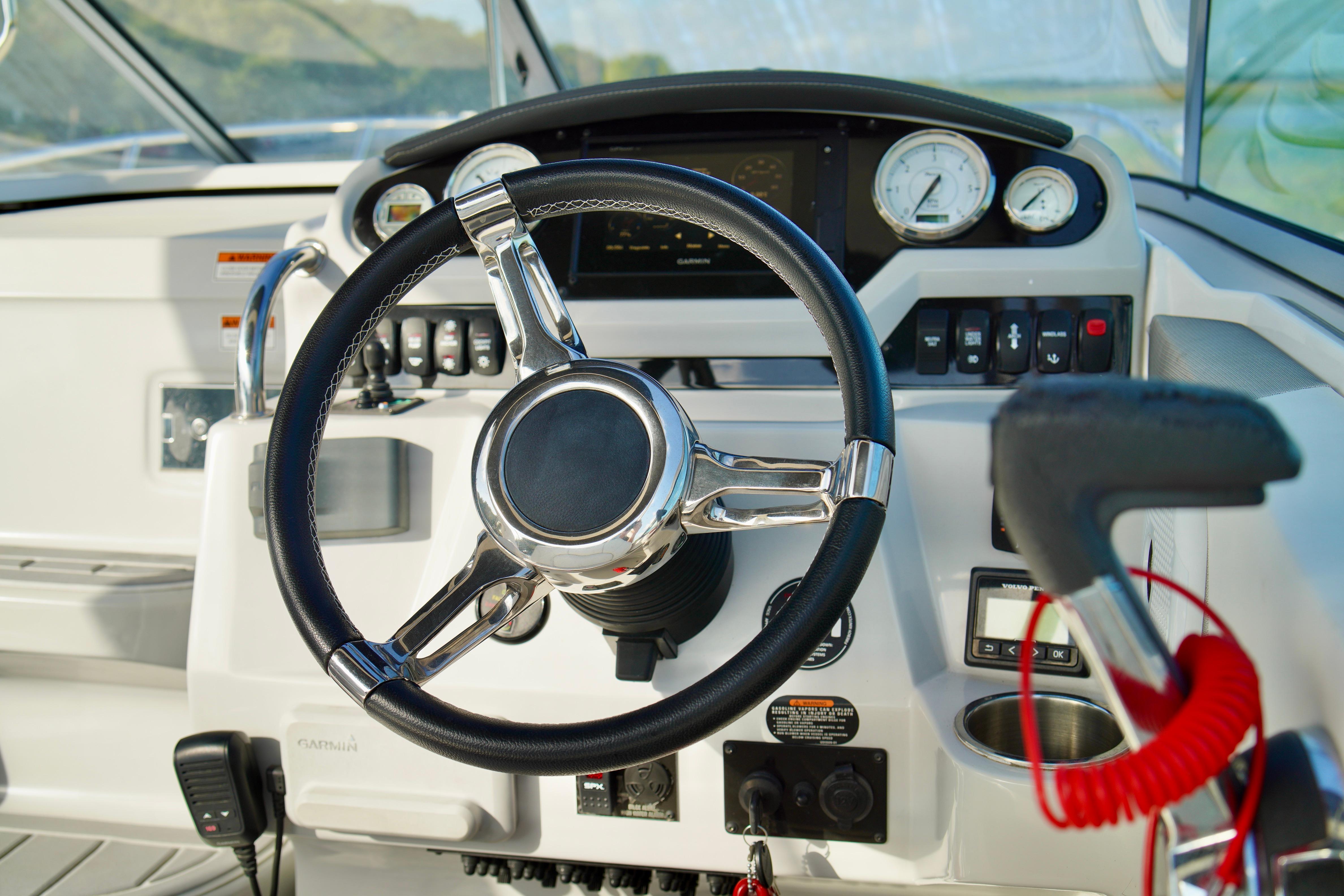 Steering wheel and dashboard of 2019 Regal 26 Express boat cockpit.