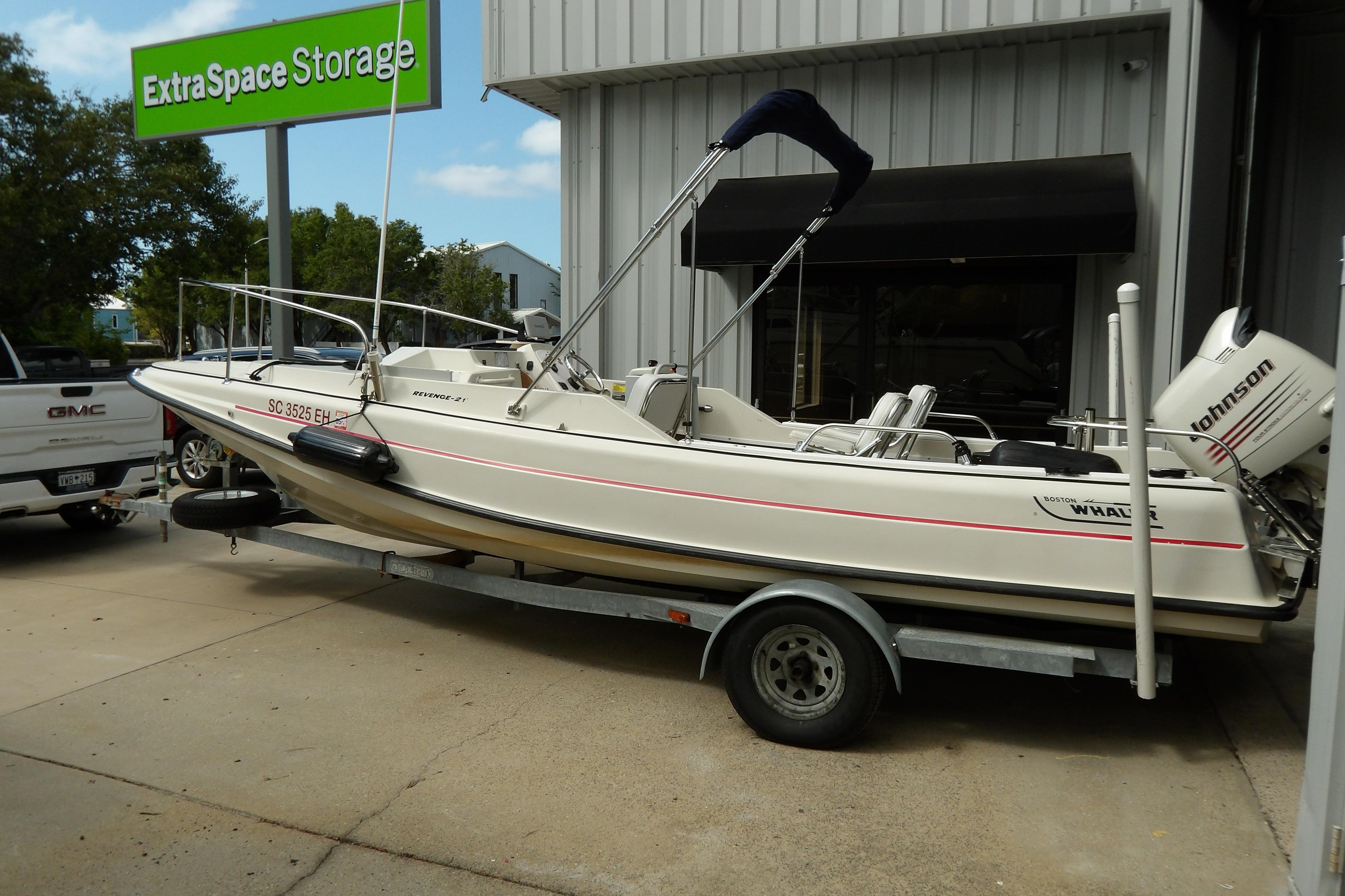 1978 Boston Whaler 21 Revenge boat on trailer near Extra Space Storage facility.