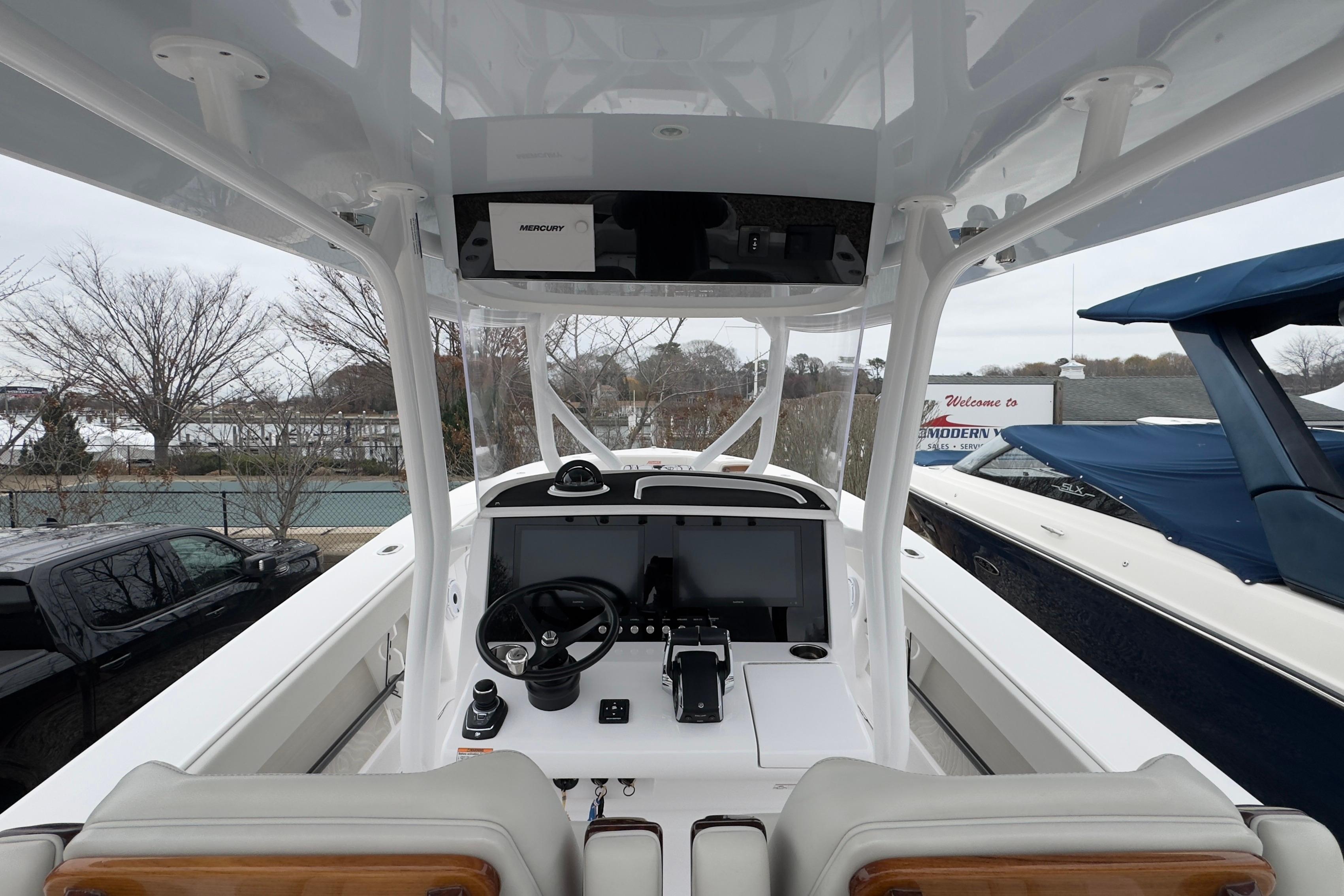 2024 Jupiter 32 FS boat cockpit with modern steering and navigation system.
