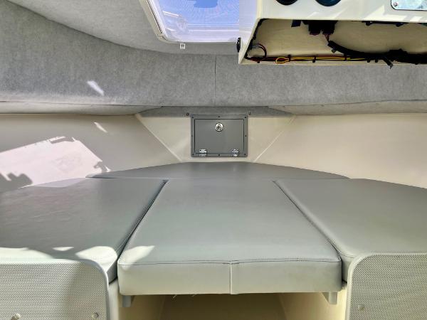 2023 Defiance Admiral 220 EX cabin interior with cushioned seating and storage.