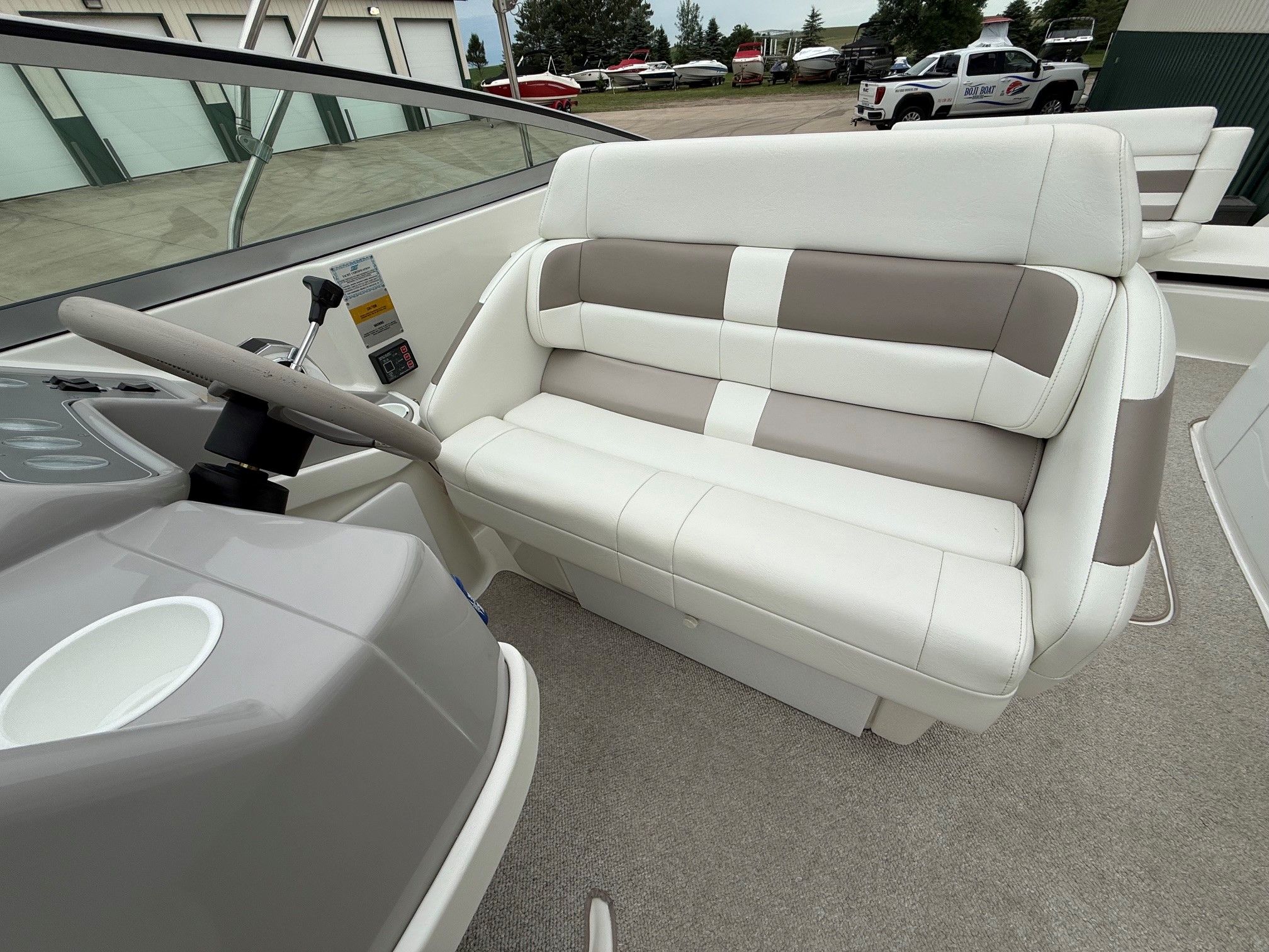 Interior of a 1998 Formula Thunderbird boat with steering wheel and bench seat.