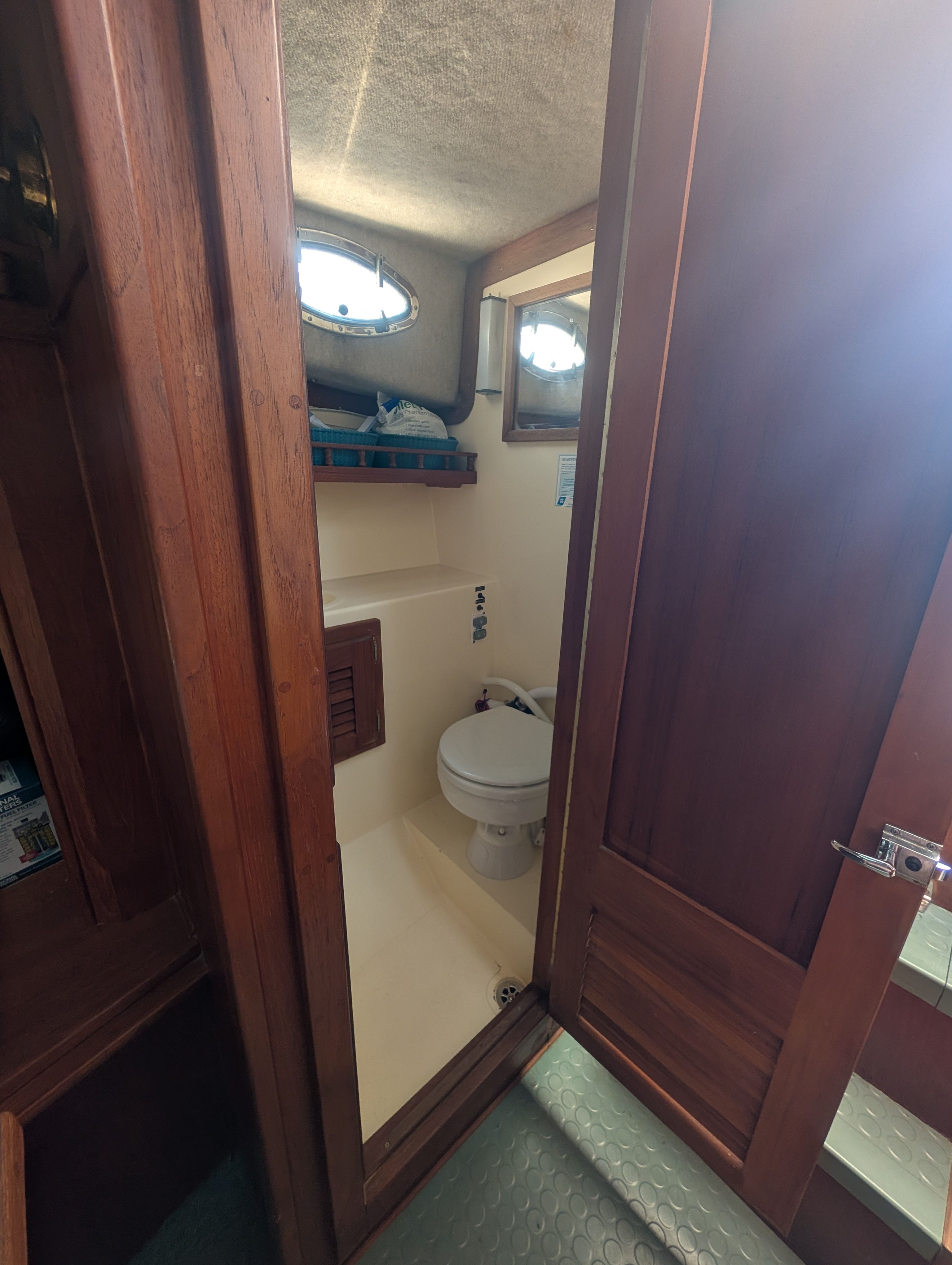Interior of a 1997 Albemarle 265 featuring a small toilet.