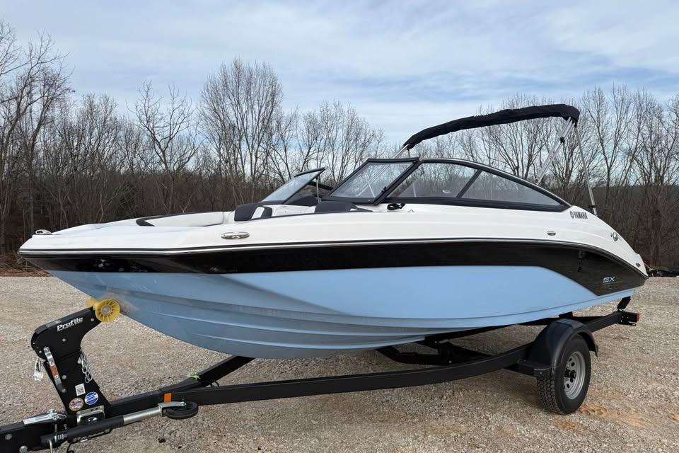 2026 Yamaha Boats SX195 on trailer, parked outdoors with trees in background.