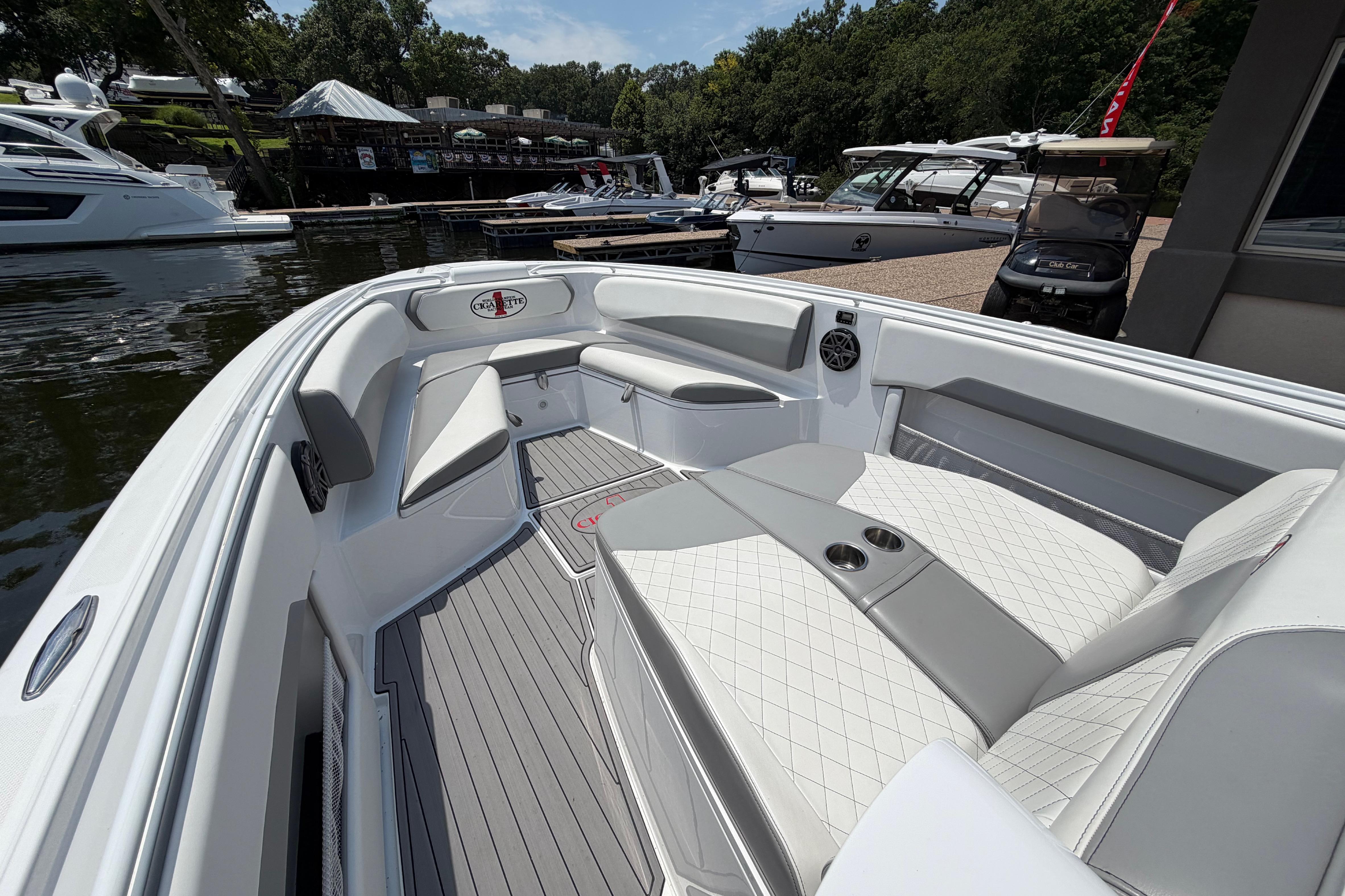 2015 Cigarette 41' Nighthawk SD Edition boat interior with luxurious seating at a marina.