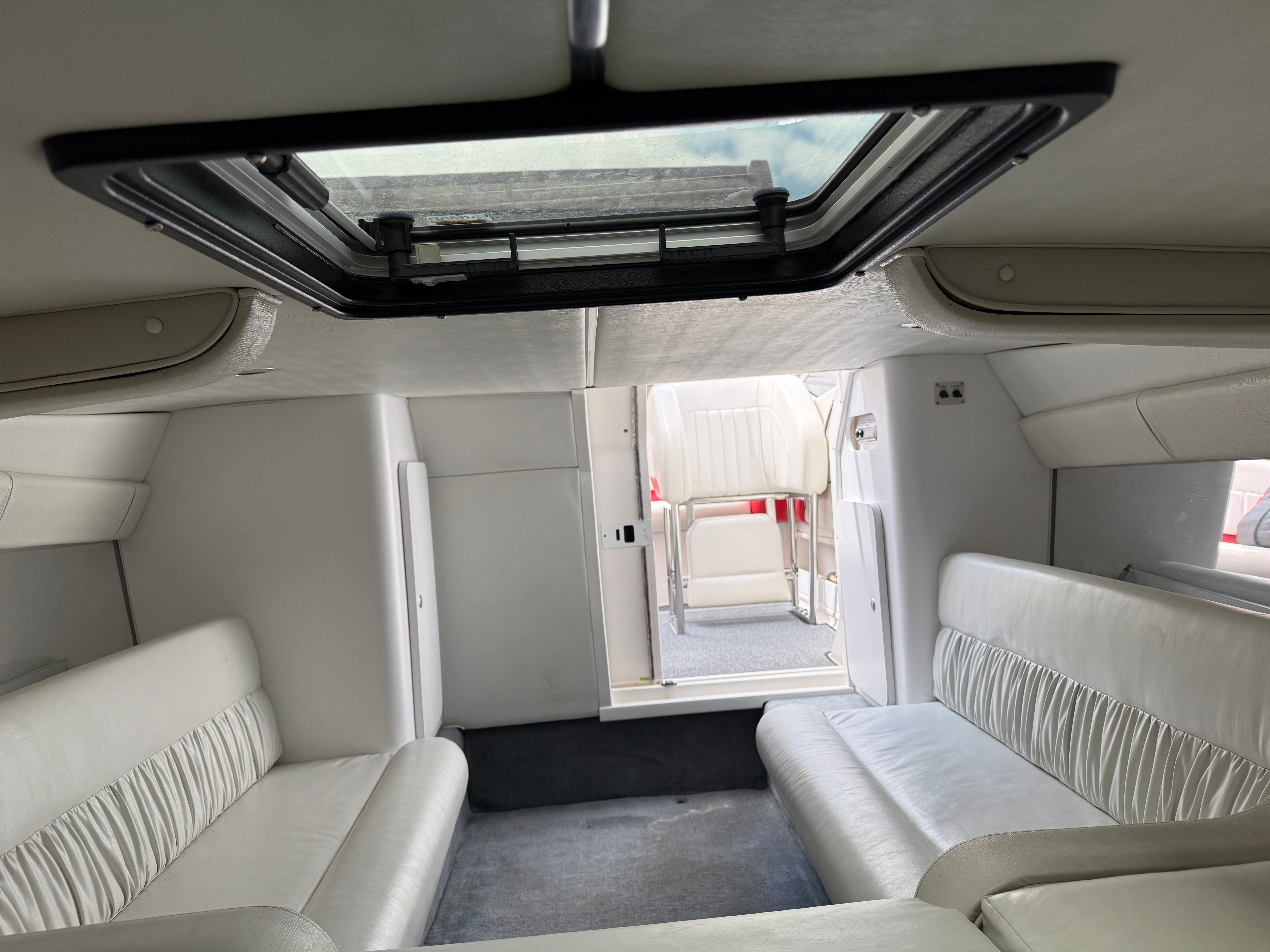 Interior of a 2001 Wellcraft 29 Scarab boat with white seating.