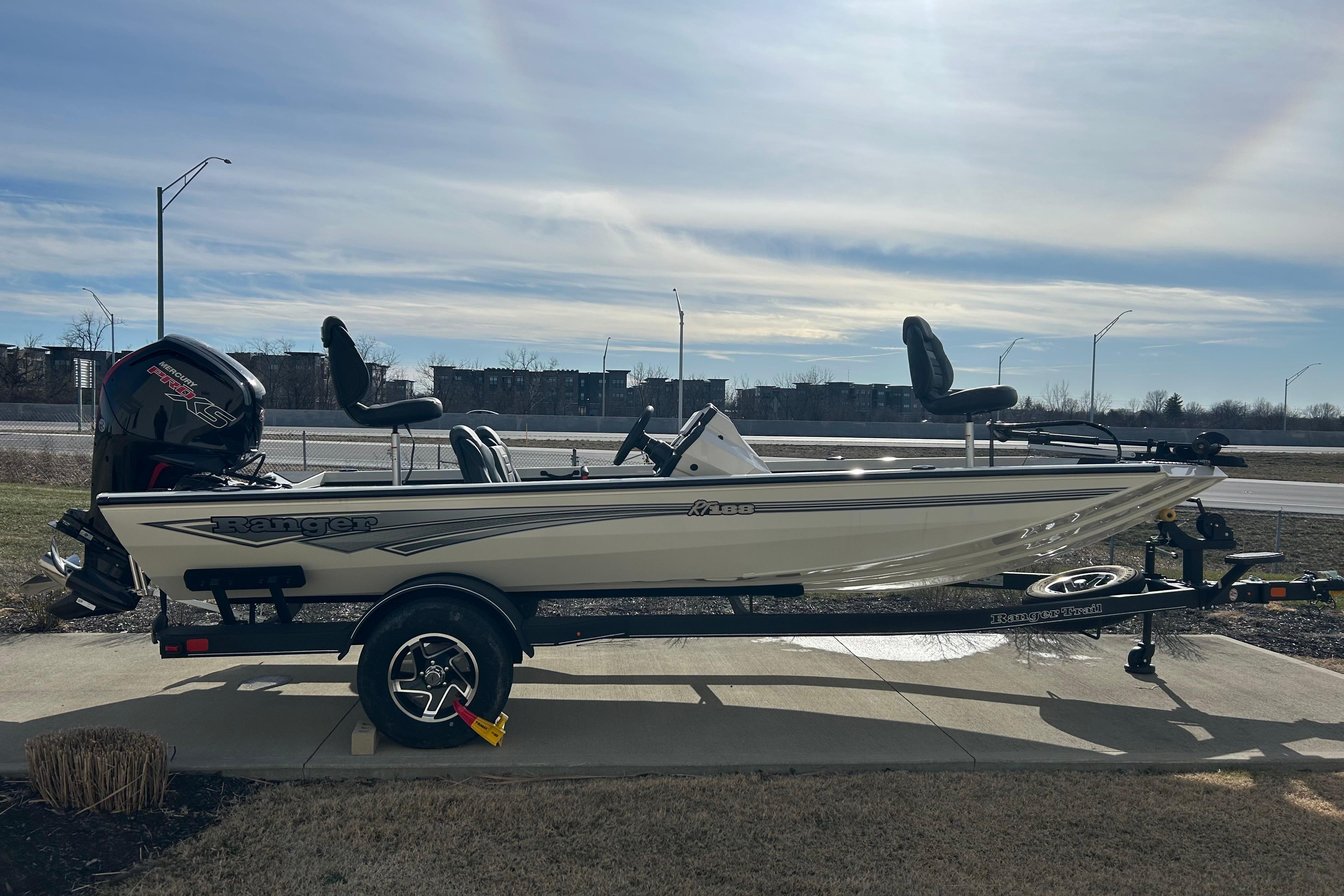 2026 Ranger RT188 fishing boat on trailer, parked outdoors under a cloudy sky.