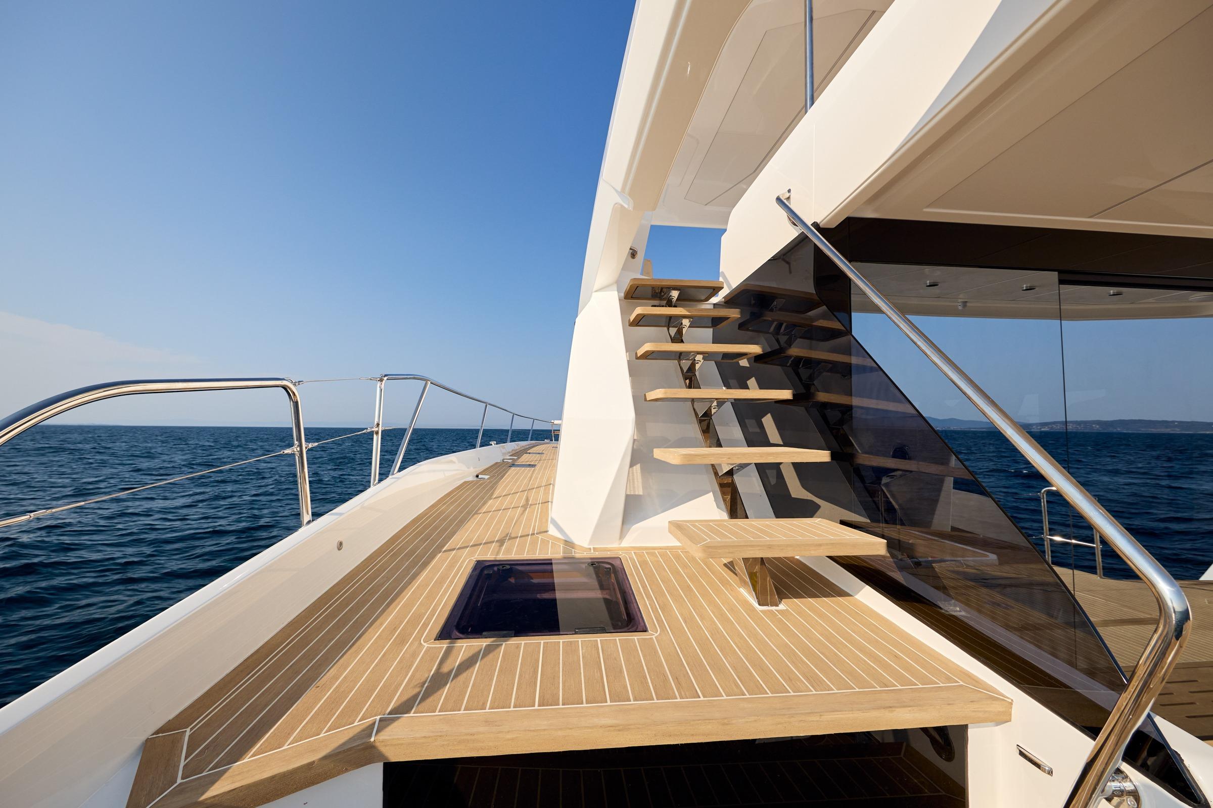 2025 Custom Omaya 50 Power Catamaran deck with modern stairs and ocean view.