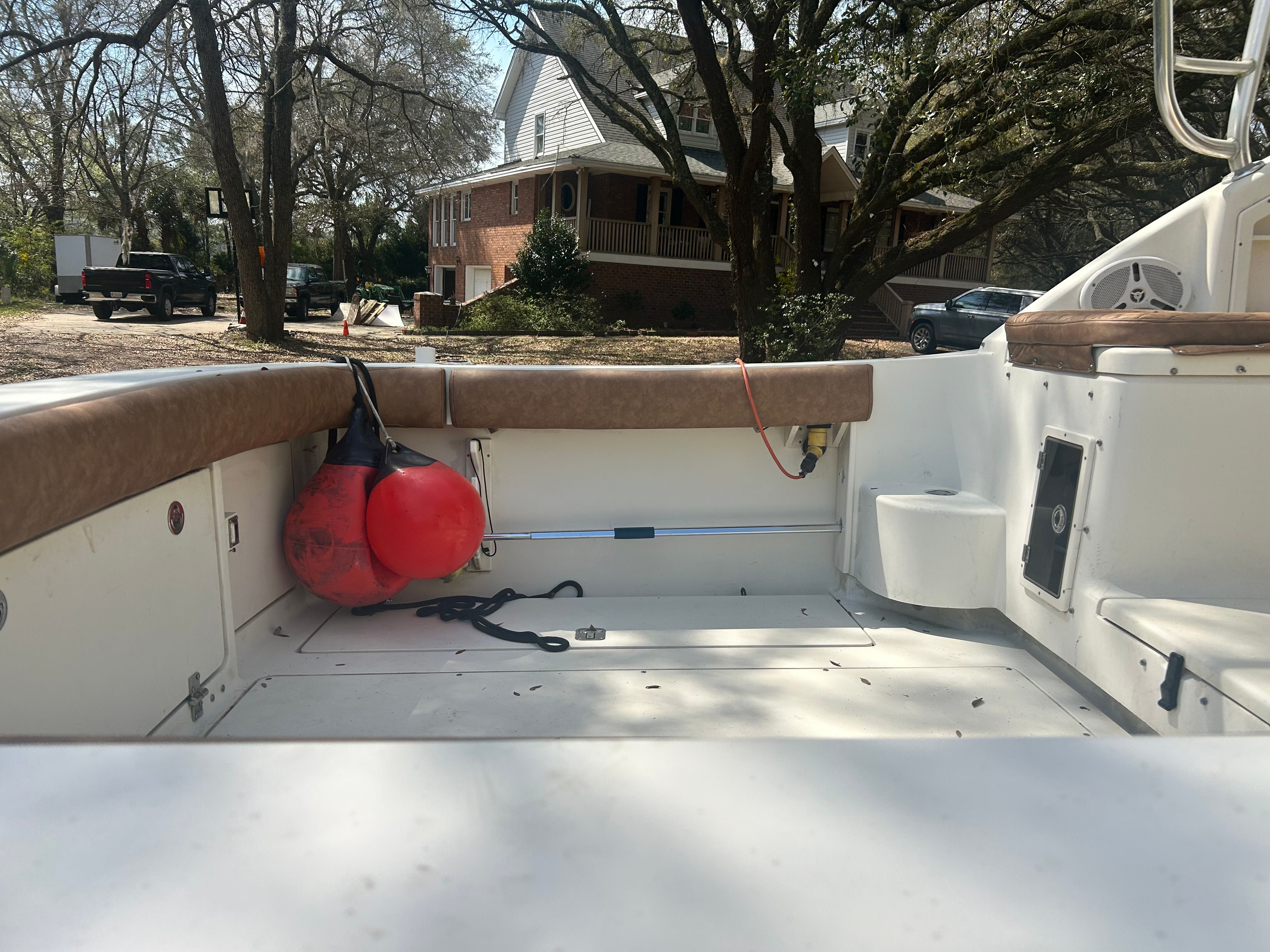 The image shows the cockpit of a 2003 Scout 280 Abaco boat with seating and fenders.