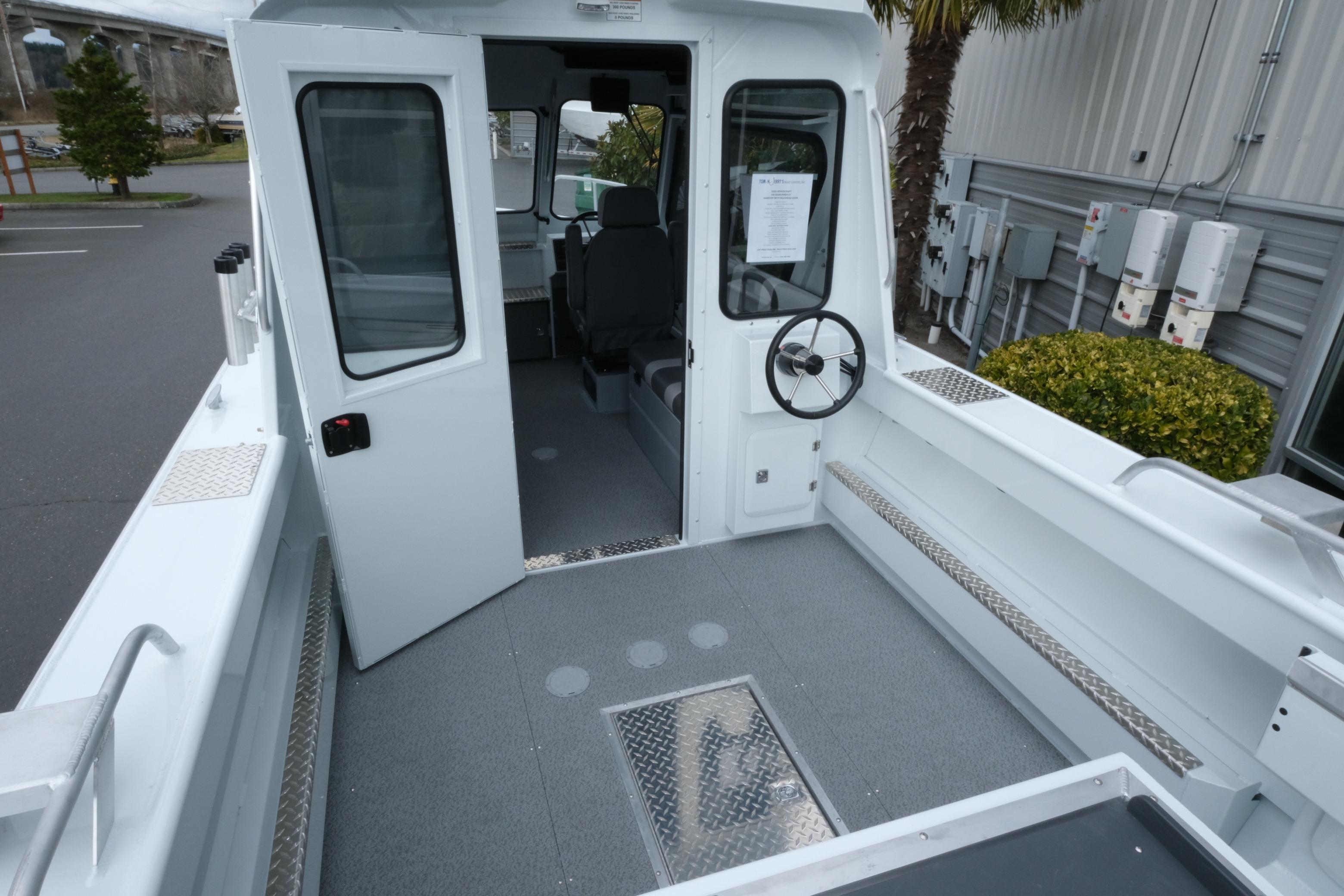 2026 Hewescraft 210 Sea Runner ET Hardtop boat interior with open cabin door.