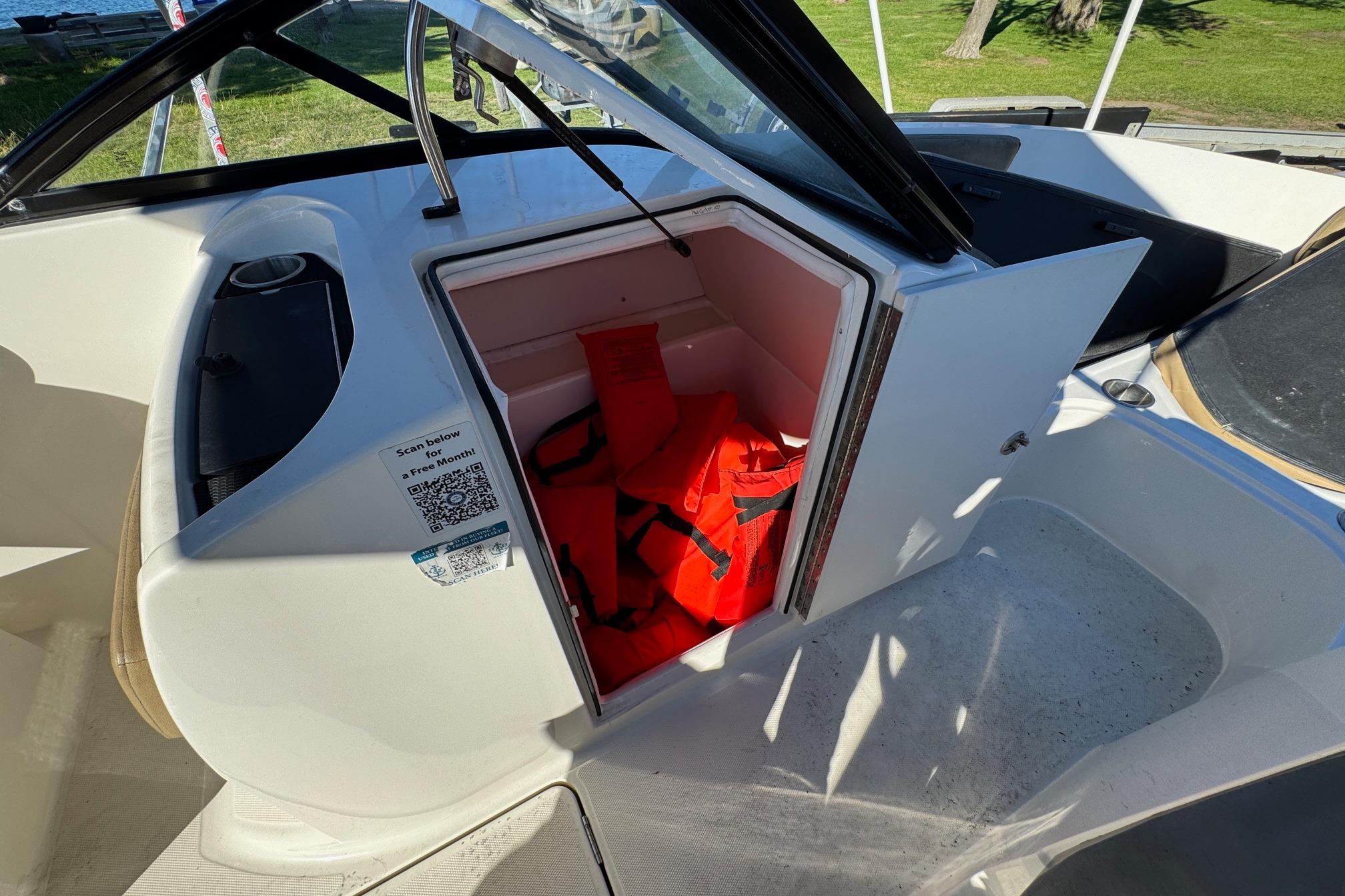 2022 Bayliner VR6 Bowrider OB storage compartment with life jackets inside.