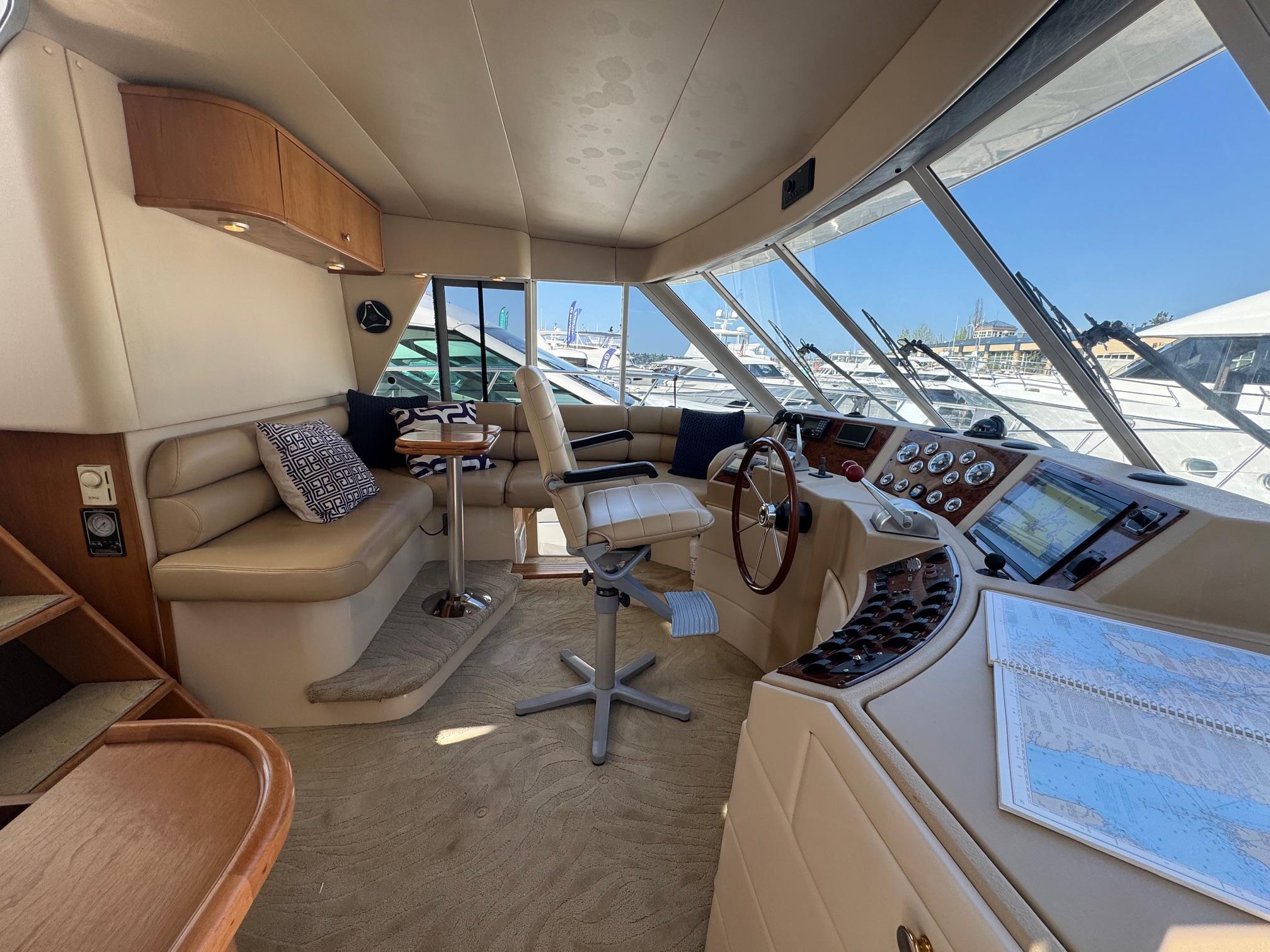 Luxurious 2004 Meridian 490 Pilothouse interior with helm, seating, and navigation equipment.
