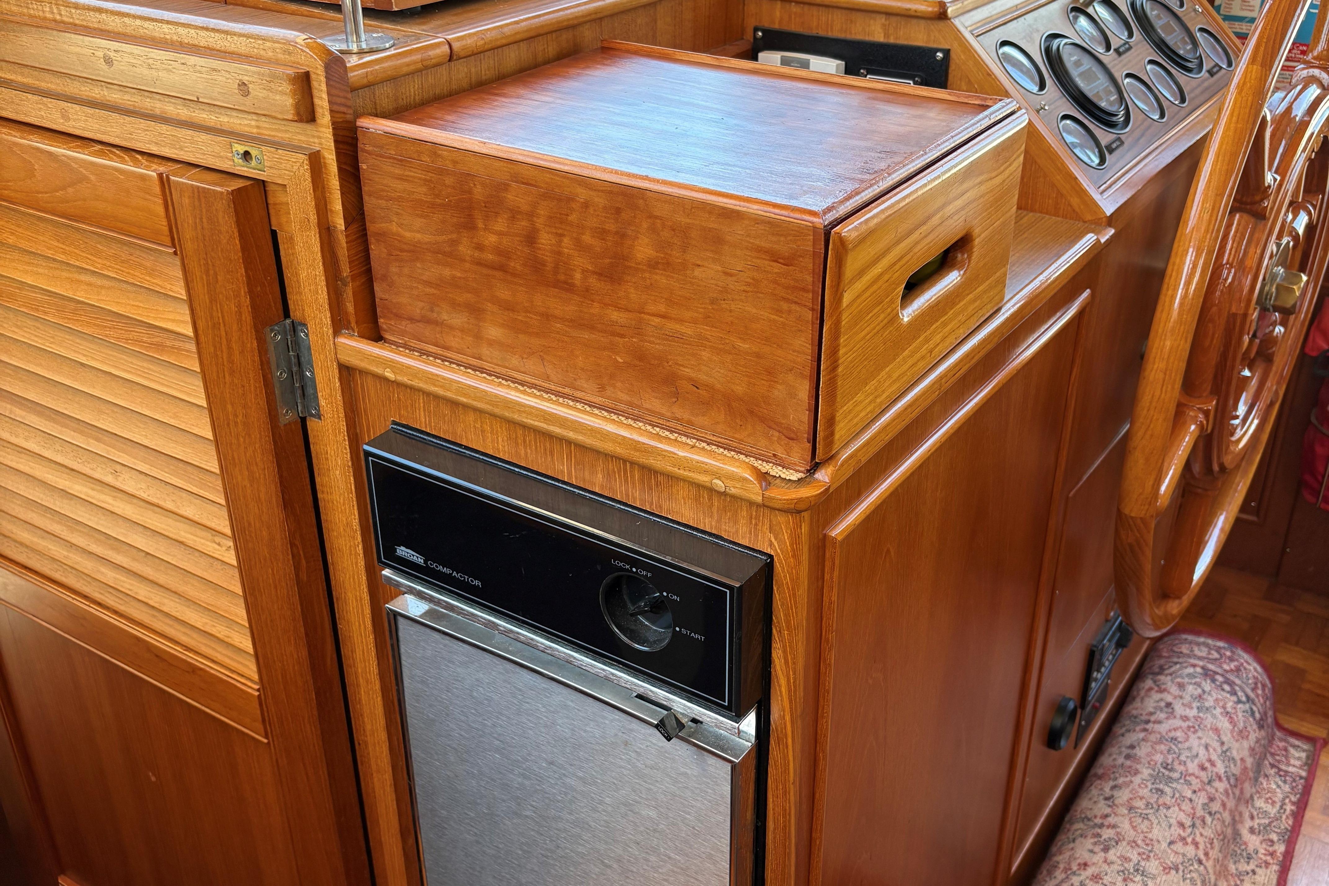 1990 Grand Banks Classic yacht interior with wooden cabinetry and control panel.
